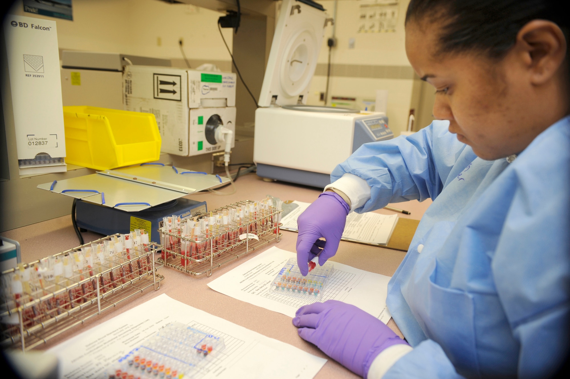 Army Reserve Staff Sgt. Shawntel Suiter, Armed Services Whole Blood Processing Laboratory/East lab technician, carefully drops red blood cells into testing trays to confirm the blood type of each incoming blood plasma unit March 6. The primary mission of the ASWBPL is to supply blood and blood products to the men and women serving in the Armed Forces. Their efforts have directly saved countless lives of those fighting in Iraq and Afghanistan. (U.S. Air Force photo/Carlos Cintron)