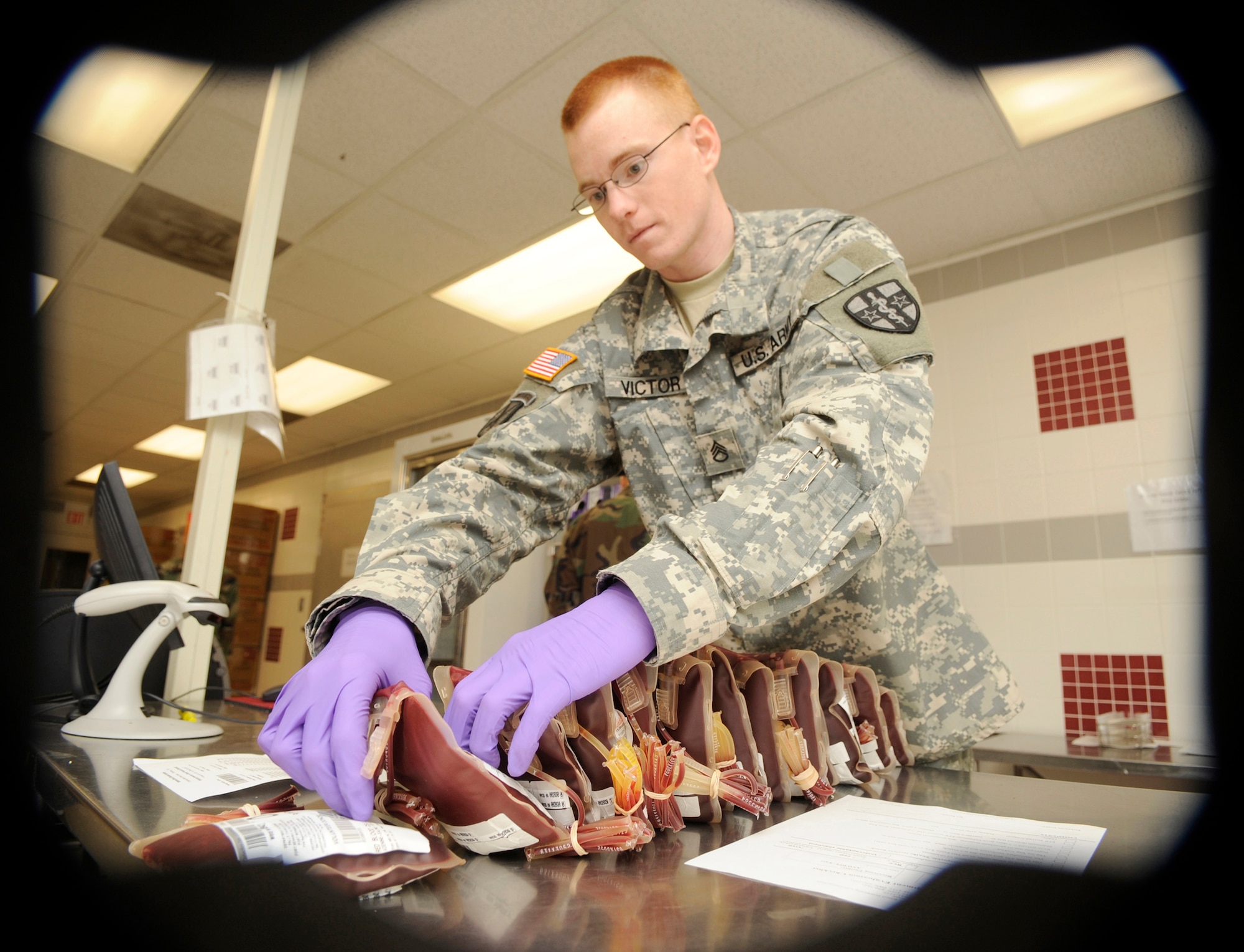 Army Reserve Staff Sgt. John Victor, Armed Services Whole Blood Processing Laboratory/East lab technician, prepares incoming shipments of blood plasma units for scanning and inventory March 6. Blood units must be placed in numerical order and crosschecked with the manifest to make sure all shipments are accurate and no mistakes are made. (U.S. Air Force photo/Carlos Cintron)