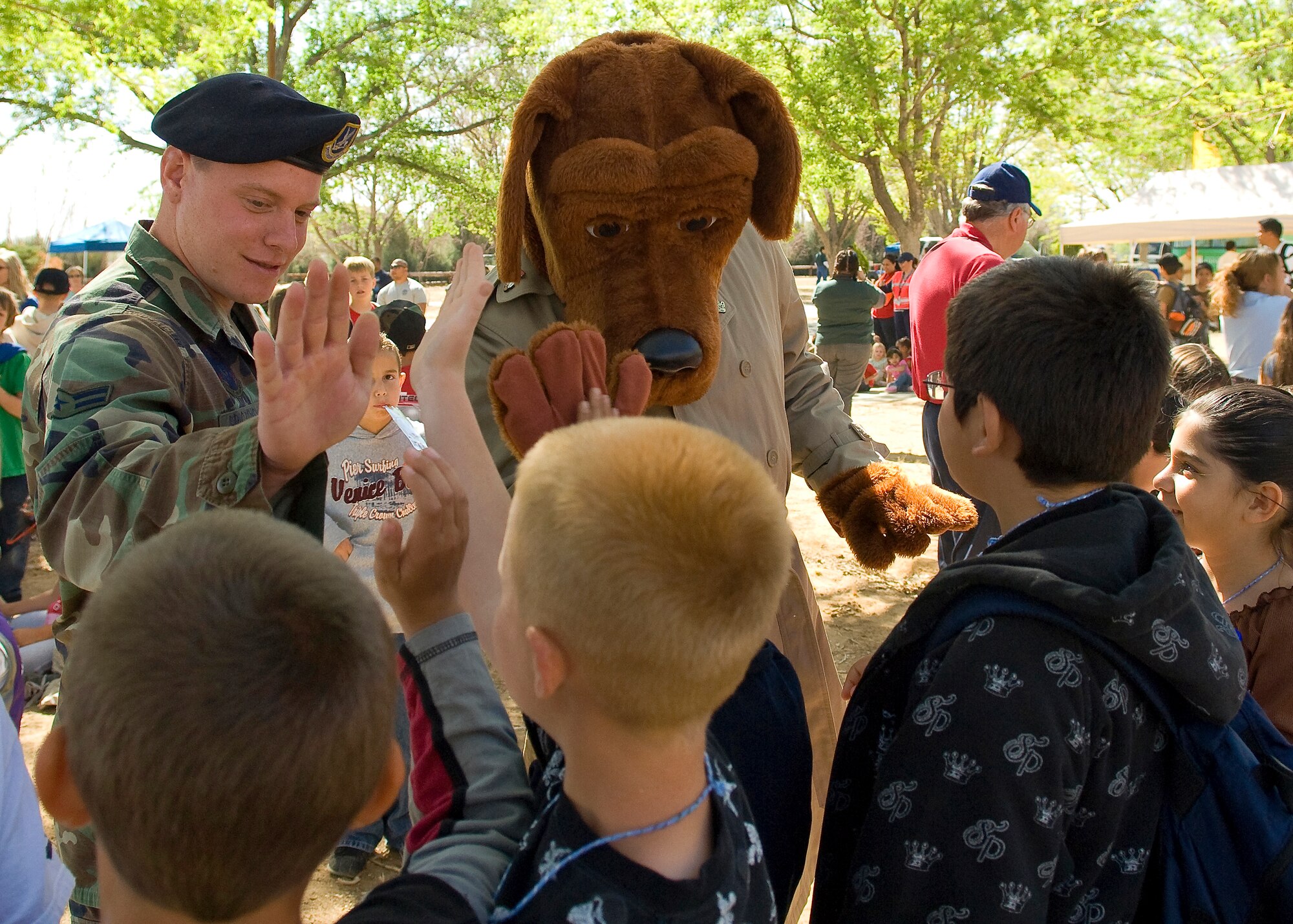 McGruff, the crime-fighting  dog, gives high fives to base children during Earth Day celebration April 17, 2008. McGruff is one of the featured mascots during an Earth Day celebration at the Center of Excellence April 21, from 10 a.m. to 2 p.m. (U.S. Air Force photo/Mike Cassidy)
