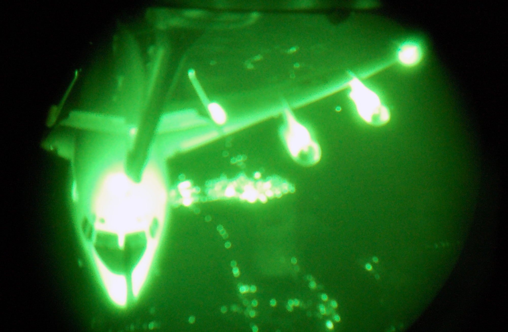 Through the lens of night vision goggles, an E-8C Joint Surveillance Target Attack Radar System aircraft is refueled by a KC-10 Extender from McGuire Air Force Base, N.J., on April 9, 2009, somewhere over the southeastern United States.  The mission was special for Staff Sgt. Kenneth Essick, boom operator for the 2nd Air Refueling Squadron on McGuire, because he refueled his father's E-8C from the 116th Air Control Wing of Robins AFB, Ga.  His father, Chief Master Sgt. Randal Money, was on his final flight as a flight engineer for the E-8C.  (U.S. Air Force Photo/Tech. Sgt. Scott T. Sturkol)