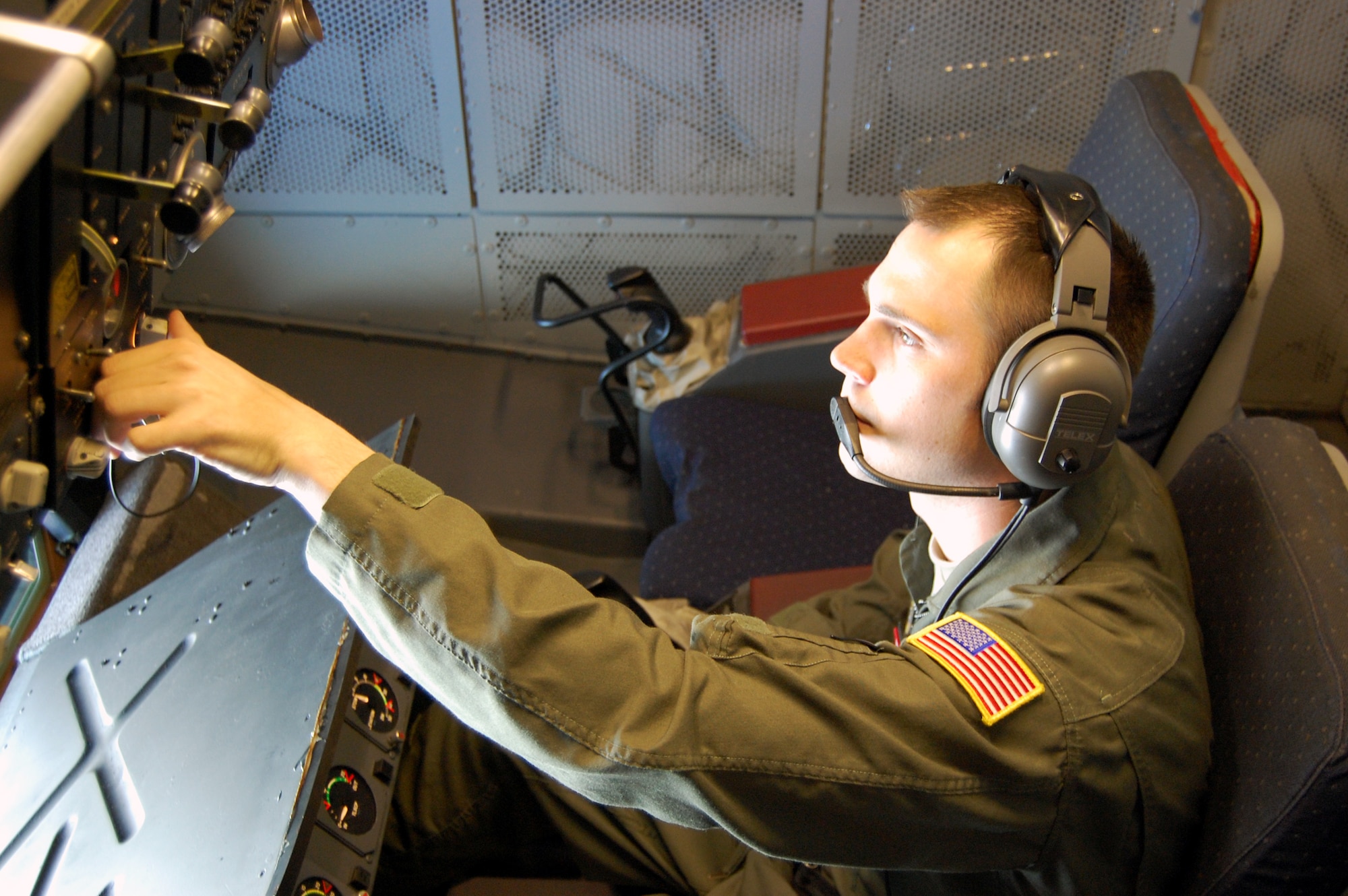 Staff Sgt. Kenneth Essick, boom operator for the 2nd Air Refueling Squadron on McGuire Air Force Base, N.J., goes through a pre-flight operations check in the boom pod of a KC-10 Extender on April 9, 2009, prior to an air refueling mission.  On that mission, Sergeant Essick refueled his father's E-8C Joint Surveillance Target Attack Radar System aircraft from the 116th Air Control Wing of Robins AFB, Ga.  His father, Chief Master Sgt. Randal Money, was on his final flight as a flight engineer for the E-8C.  (U.S. Air Force Photo/Tech. Sgt. Scott T. Sturkol)