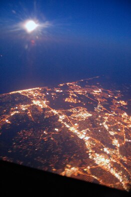 From a cruising altitude of 24,000 feet out of the window of a KC-10 Extender, this image shows a full moon over the city of Norfolk, Va.  The photo was taken during an air refueling mission for a KC-10 from McGuire Air Force Base, N.J.  (U.S. Air Force Photo/Tech. Sgt. Scott T. Sturkol)