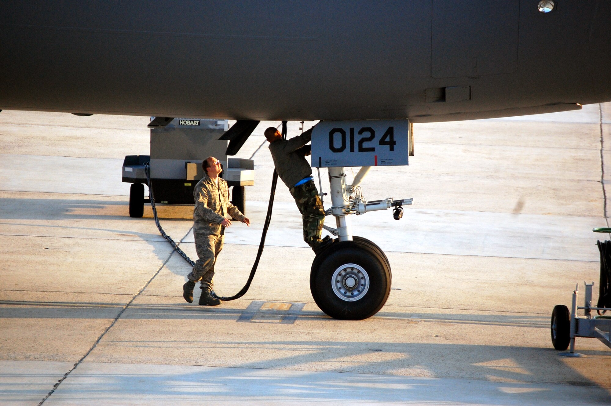 Maintenance Airmen work on a KC-10 Extender on the flightline at McGuire Air Force Base, N.J., on April 9, 2009.  The KC-10 Extender is one of types of aircraft at McGuire that helps the Air Force and Air Mobility Command meet the service's global mission to "fly, fight and win...in air, space and cyberspace." (U.S. Air Force Photo/Tech. Sgt. Scott T. Sturkol)
