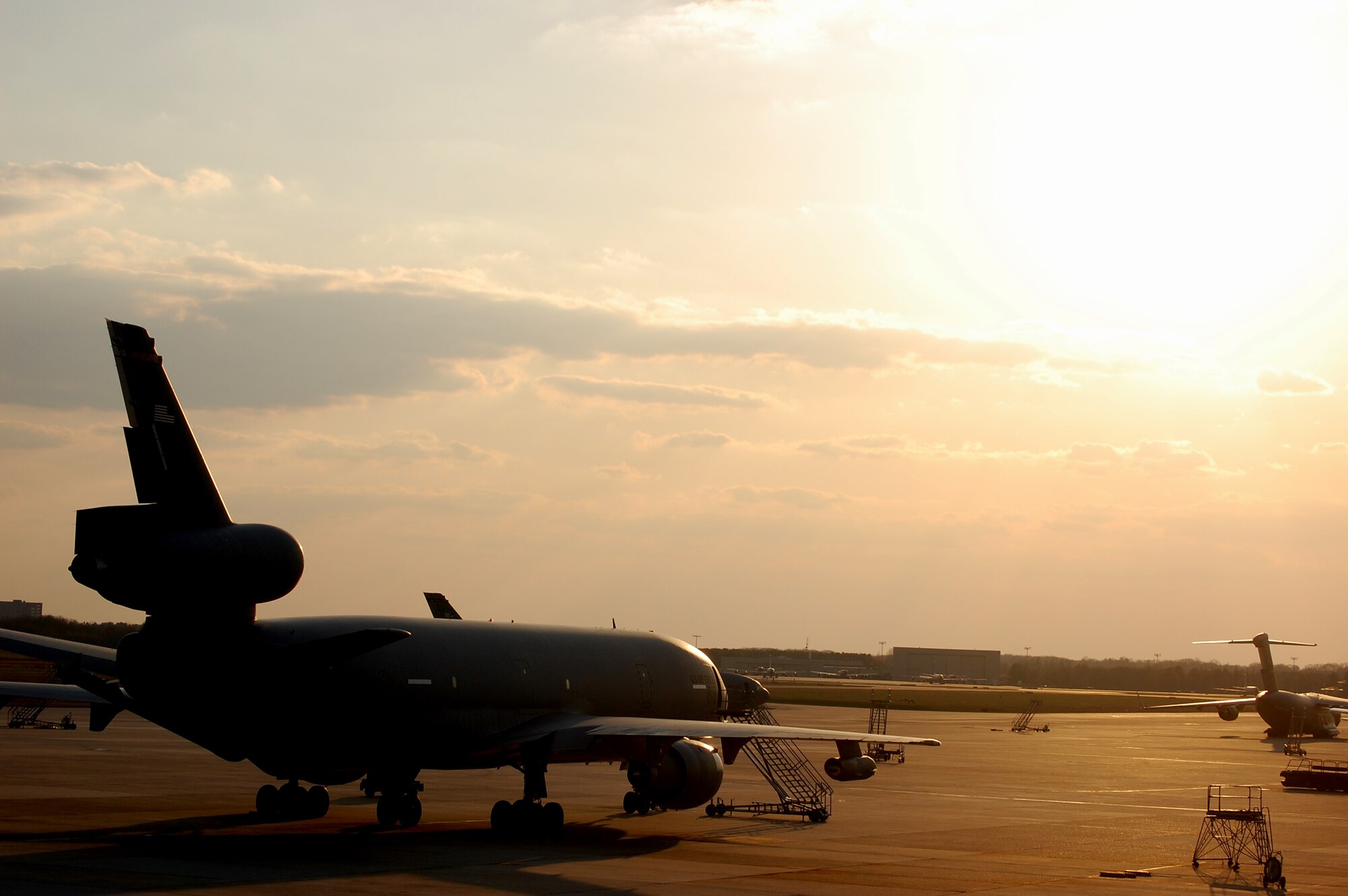 A KC-10 Extender is shadowed by the sun on the flightline at McGuire Air Force Base, N.J., on April 9, 2009.  The KC-10 Extender, an air refueling plane, is one of types of aircraft at McGuire that helps the Air Force and Air Mobility Command meet the service's global mission to "fly, fight and win...in air, space and cyberspace." (U.S. Air Force Photo/Tech. Sgt. Scott T. Sturkol)