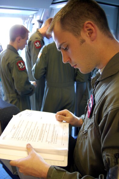 Staff Sgt. Kenneth Essick, boom operator for the 2nd Air Refueling Squadron on McGuire Air Force Base, N.J., goes through a pre-flight checklist in a KC-10 Extender on April 9, 2009, prior to an air refueling mission.  On that mission, Sergeant Essick refueled his father's E-8C Joint Surveillance Target Attack Radar System aircraft from the 116th Air Control Wing of Robins AFB, Ga.  His father, Chief Master Sgt. Randal Money, was on his final flight as a flight engineer for the E-8C.  (U.S. Air Force Photo/Tech. Sgt. Scott T. Sturkol)