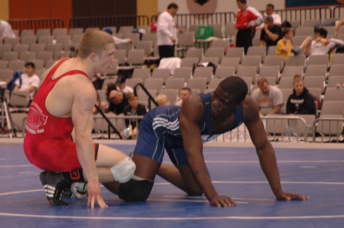 Airman Kevin Justin, 96 Security Forces Squadron, Eglin Air Force Base, looks at his opponents who is preparing to start the partera position during the FILA Junior National Wrestling tournament April 8 in Las Vegas.