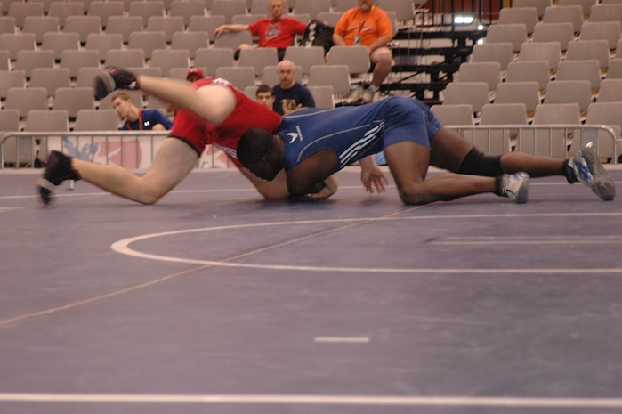 Airman Kevin Justin, 96 Security Forces Squadron, Eglin Air Force Base, prepares to front headlock one of his opponents during the FILA Junior National Wrestling tournament April 8 in Las Vegas.