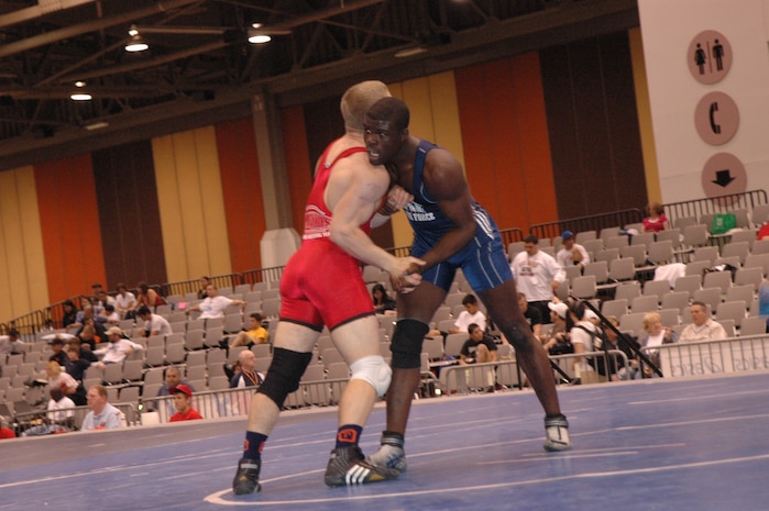 Airman Kevin Justin, 96 Security Forces Squadron, Eglin Air Force Base, clinches with one of his opponents during the FILA Junior National Wrestling tournament April 8 in Las Vegas.