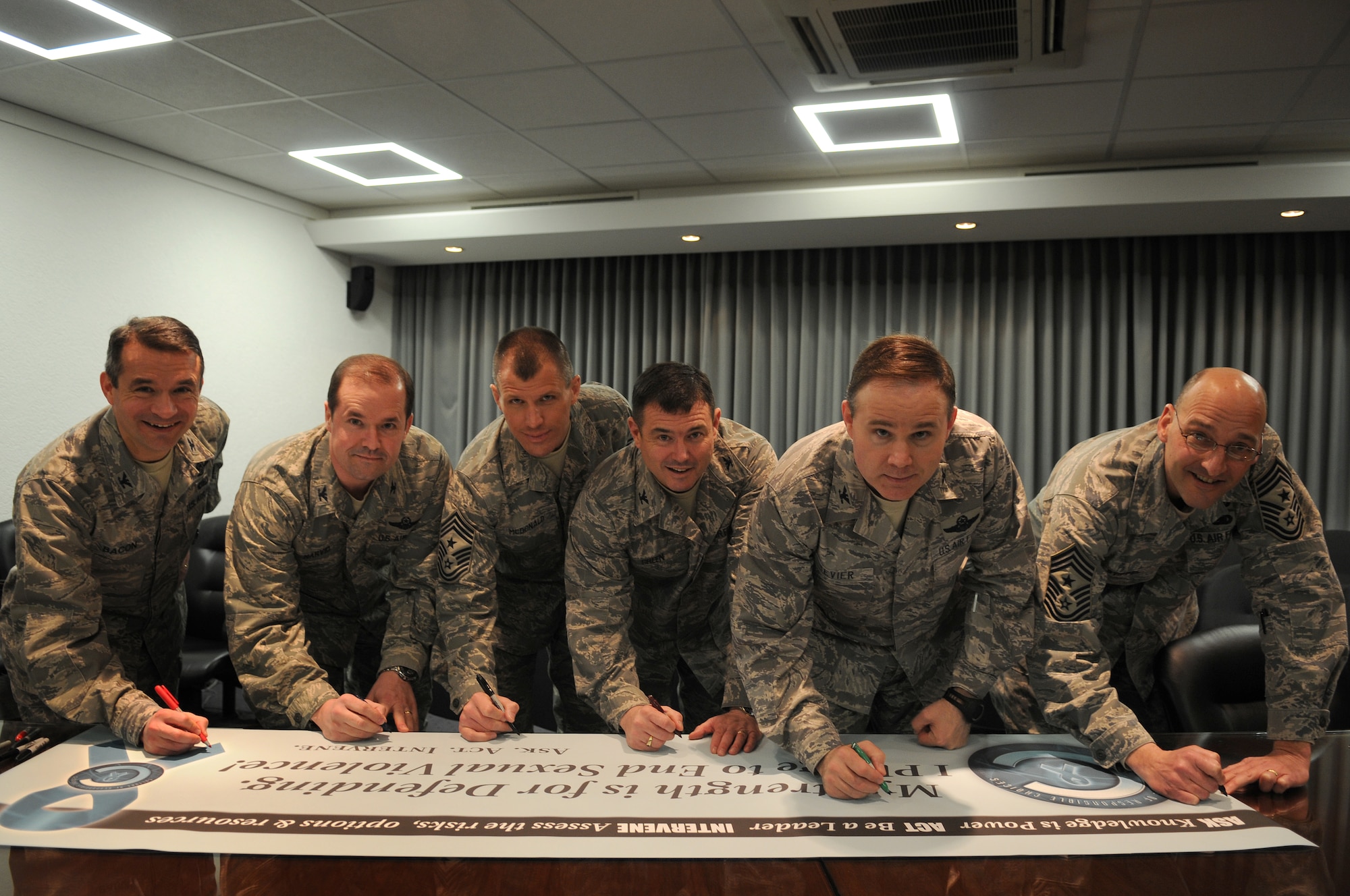 From left to right, Col. Donald Bacon, 435th Air Base Wing commander; Col. Juan Narvid, 521st Air Mobility Operations Wing vice commander; Chief Master Sgt. Steve McDonald, 86th Airlift Wing Command Chief Master Sergeant; Col. Gus Green, 435th ABW vice commander; Col. Douglas Sevier, 86th AW vice commander; and Chief Master Sgt. Mitchell Stippel, 435th ABW Command Chief Master Sergeant, sign the SARC banner April 1 at Ramstein Air Base, pledging to help raise awareness for the month. (U.S. Air Force photo by Airman 1st Class Grovert Fuentes-Contreras) (U.S. Air Force photo by Airman 1st Class Grovert Fuentes-Contreras)
