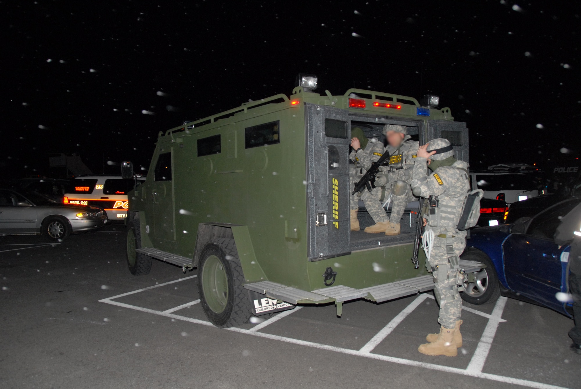 Unidentified members of the sheriff?s SWAT Team prepare to assault a national affiliated gang called the Bloods. The early morning raid netted numerous arrests, and weapons and drug seizure.       