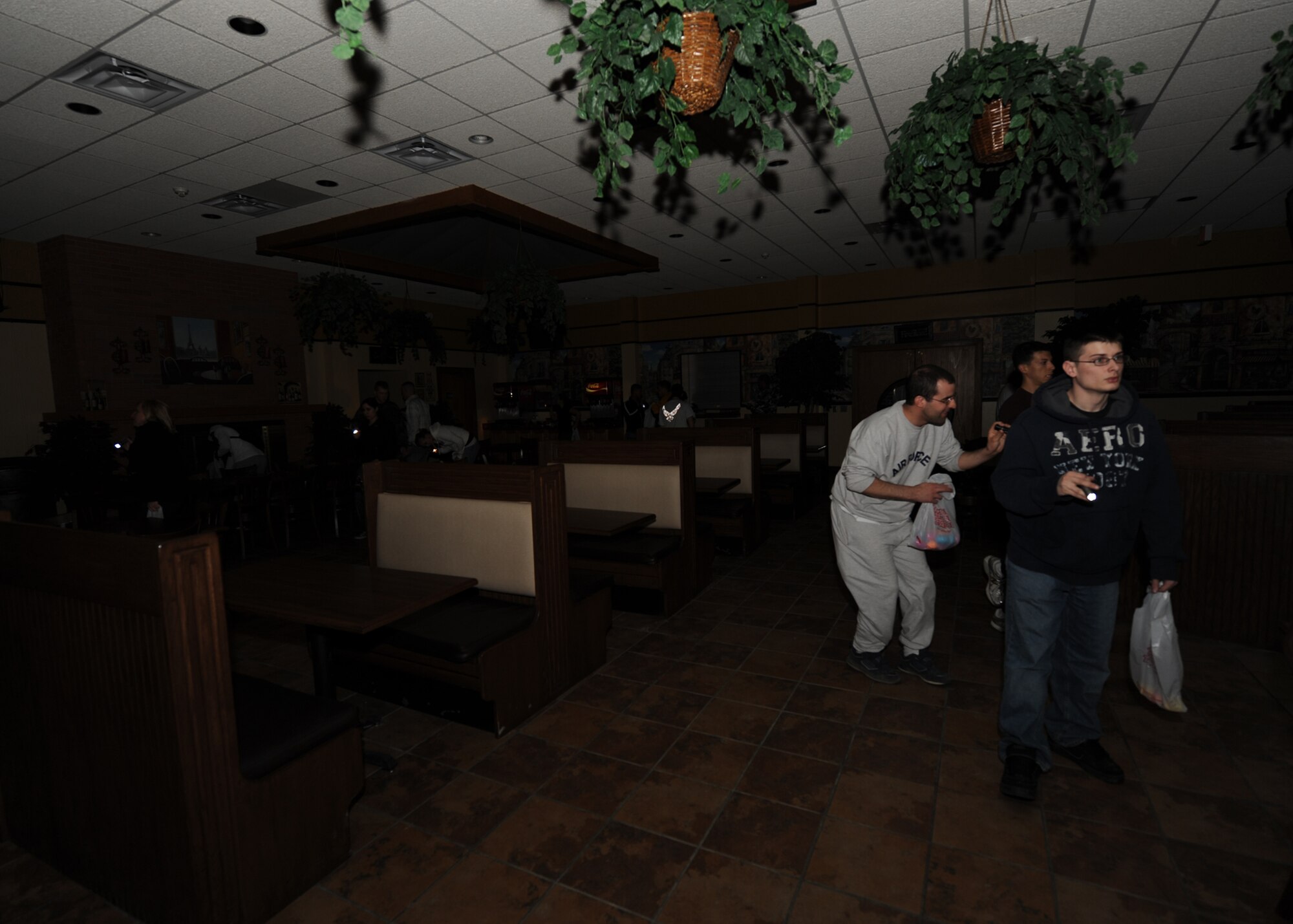 MINOT AIR FORCE BASE, N.D. - Airmen search for eggs in the dark during the Airmen's Flashlight Easter Egg Hunt at the Rough Rider Community Center here April 9. The egg hunt was open to Airmen who were E-4 and below, and featured cash awards totaling $500. (U.S. Air Force photo by Senior Airman Sharida Jackson)