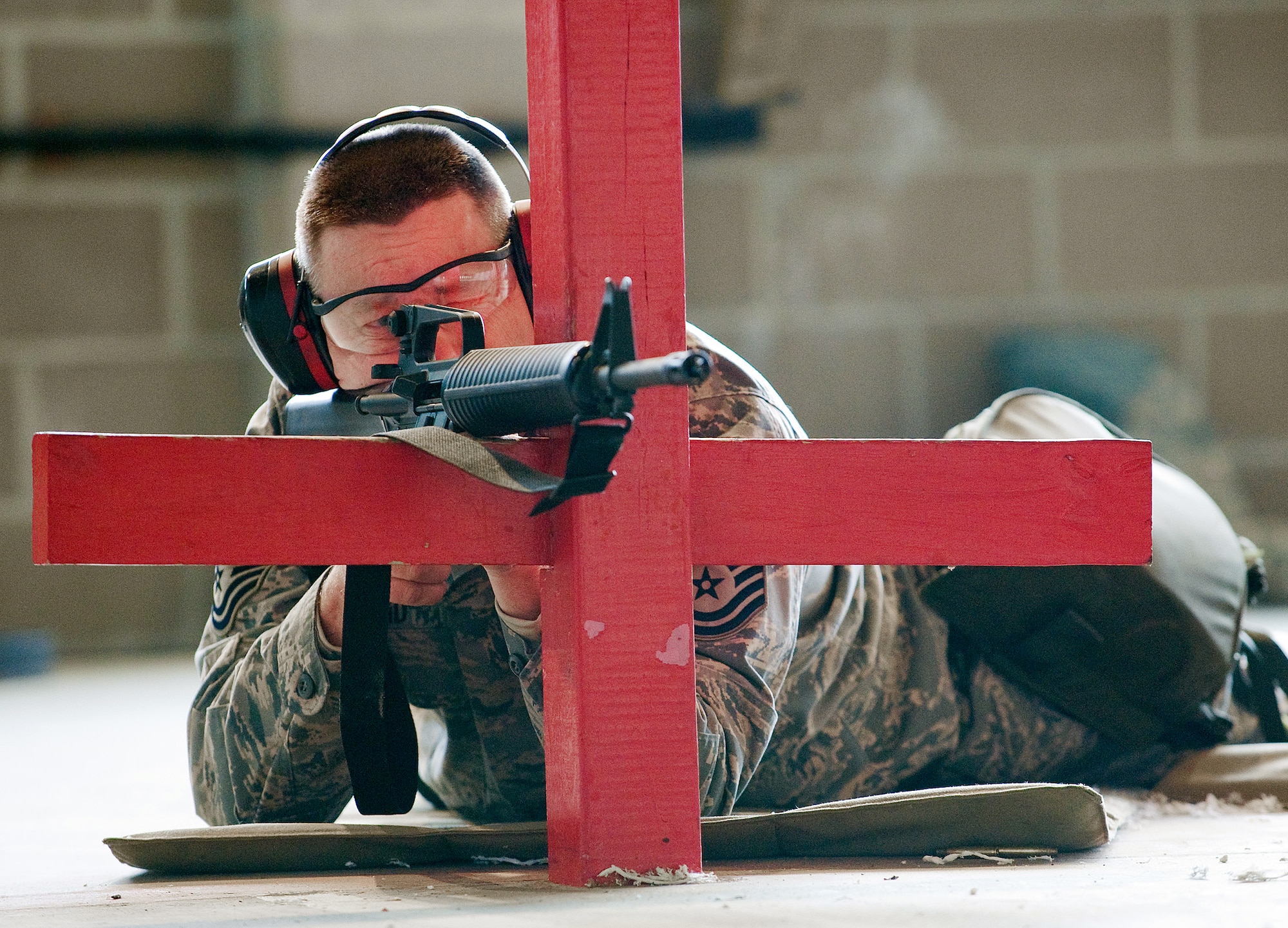 Master Sgt. John Reid, 436th Civil Engineer Squadron infrastructure superintendent, poses in the prone position to check out his front and rear sights during an M-16 Firing Class April 1 at the 436th Security Forces Squadron Combat Arms Training and Maintenance. Sergeant Reid attended the mandatory class to qualify with his weapon for a short-notice deployment to Afghanistan. (U.S. Air Force photo/ Tom Randle)