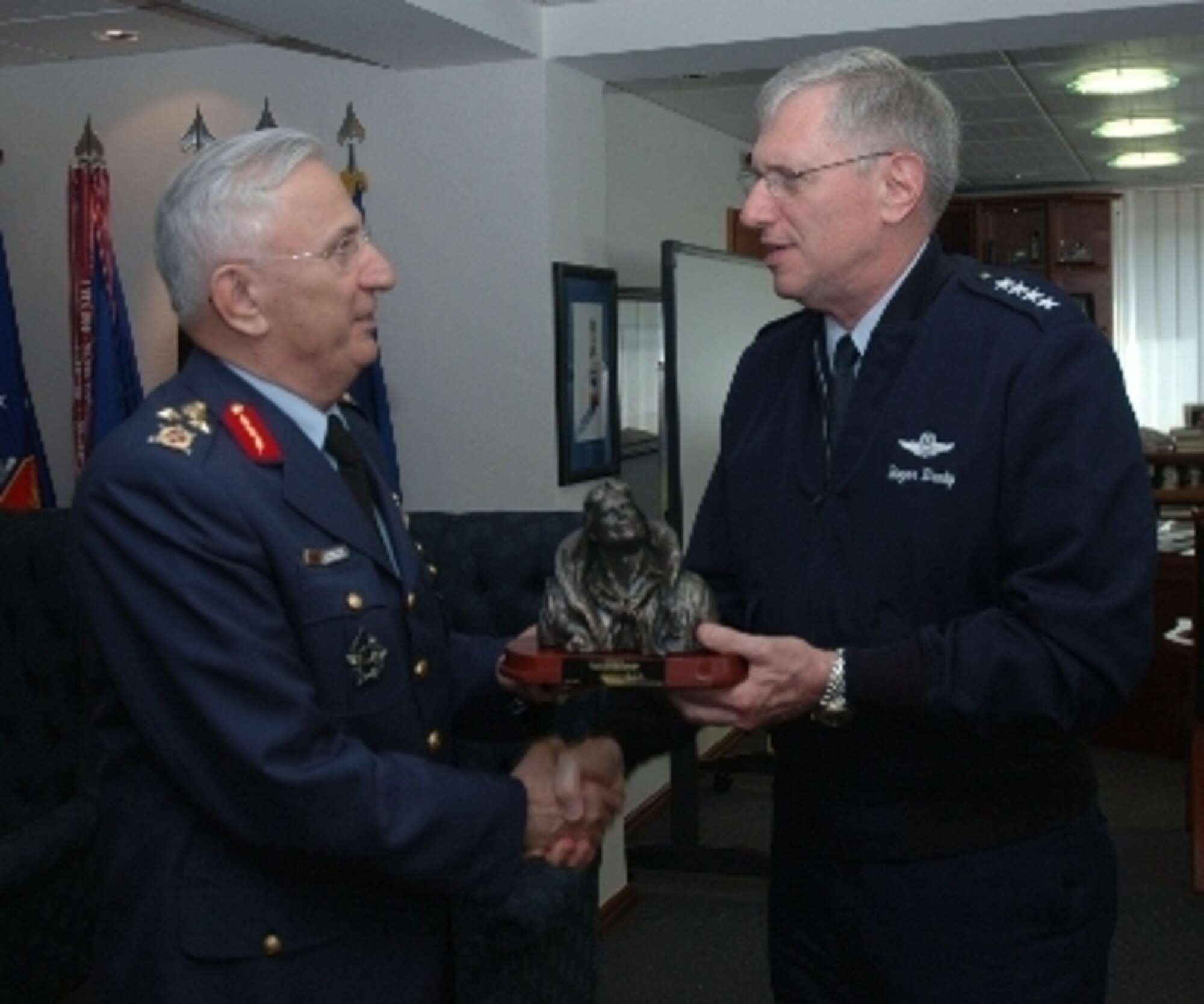 Gen. Roger A. Brady, commander of U.S. Air Forces in Europe and NATO Allied
Air Component Command, presents the sculpture "Flying Leather" to Turkish Air Force Chief of Staff Gen. Aydogan Babaoglu April 8, 2009. General  Babaoglu visited USAFE headquarters, the Warrior Preparation Center in Einsiedlerhof, Germany, and the Polygone Electronic Range Complex.