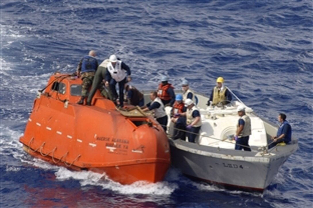 A team from the amphibious assault ship USS Boxer tows the lifeboat from the Maersk-Alabama to the Boxer, April 13, 2009, to be processed for evidence after the successful rescue of Merchant Marine Capt. Richard Phillips. Phillips was held captive by suspected Somali pirates in the lifeboat in the Indian Ocean for five days after a failed hijacking attempt off the Somali coast.
   