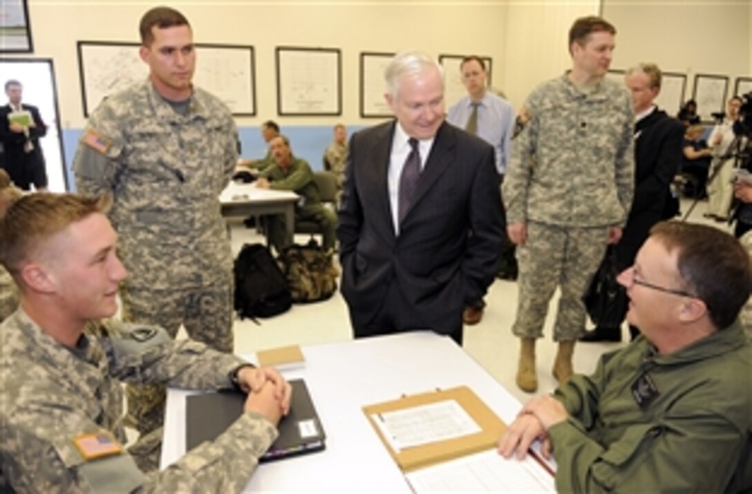 Defense Secretary Robert M. Gates talks with initial flight students and their instructors on Cairns Army Airfield, Ala., April 14, 2009, during a two-day trip to Alabama. 