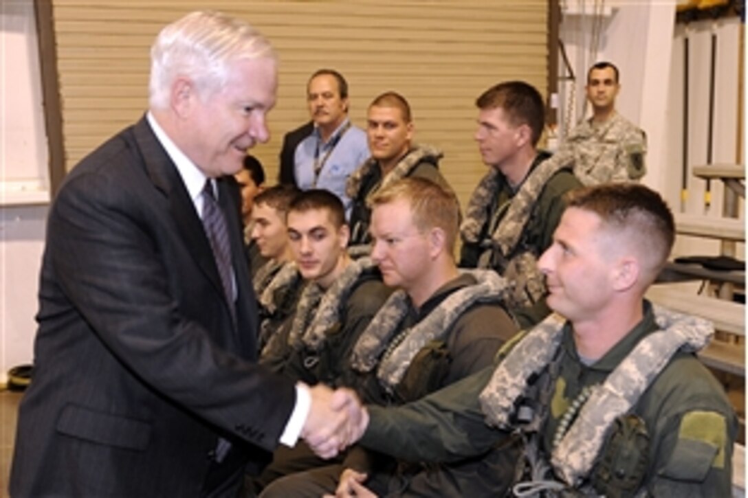Defense Secretary Robert M. Gates shakes hands with Army members attending Helicopter Overwater Survival Training on Hanchey Army Airfield, Ala., April 14, 2009. 