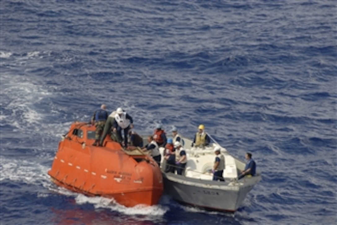A team from the USS Boxer (LHD 4) tows one of the Maersk Alabama’s lifeboats to the Boxer to be processed for evidence in the Indian Ocean on April 13, 2009.  Capt. Richard Phillips was held captive in the lifeboat by suspected Somali pirates for five days following a failed hijacking attempt off the Somali coast.  The Boxer is deployed as part of Boxer Amphibious Readiness Group along with the 13th Marine Expeditionary Unit supporting Maritime Security Operations in the Navy’s 5th fleet area of operations.  