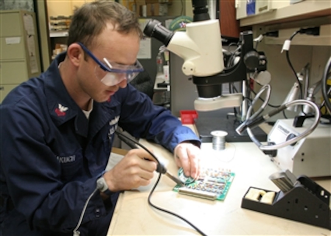 U.S. Navy Petty Officer 1st Class Phillip Makuch conducts a component replacement on a hydraulic power unit circuit card at Ingleside, Texas, on April 7, 2009.  Mine Countermeasures Class Squadron and South Central Regional Maintenance Center collaborated to investigate a viable means of repairing systems that sailors were not able to do in the past, saving the Navy significantly over the next few years.  DoD photo by Senior Chief William Rhine, U.S. Navy.  (Released)