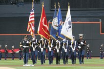 A joint-service color guard marches onto the field as part of the pre-game ceremony for the New York Mets inaugural game at Citi Field, April 13. The Marines unfurled an outfield-sized flag and flew F-18 Hornets overhead to kick-off the season in the new stadium. (Official U.S. Marine Corps Photo by Sgt. Randall A. Clinton)