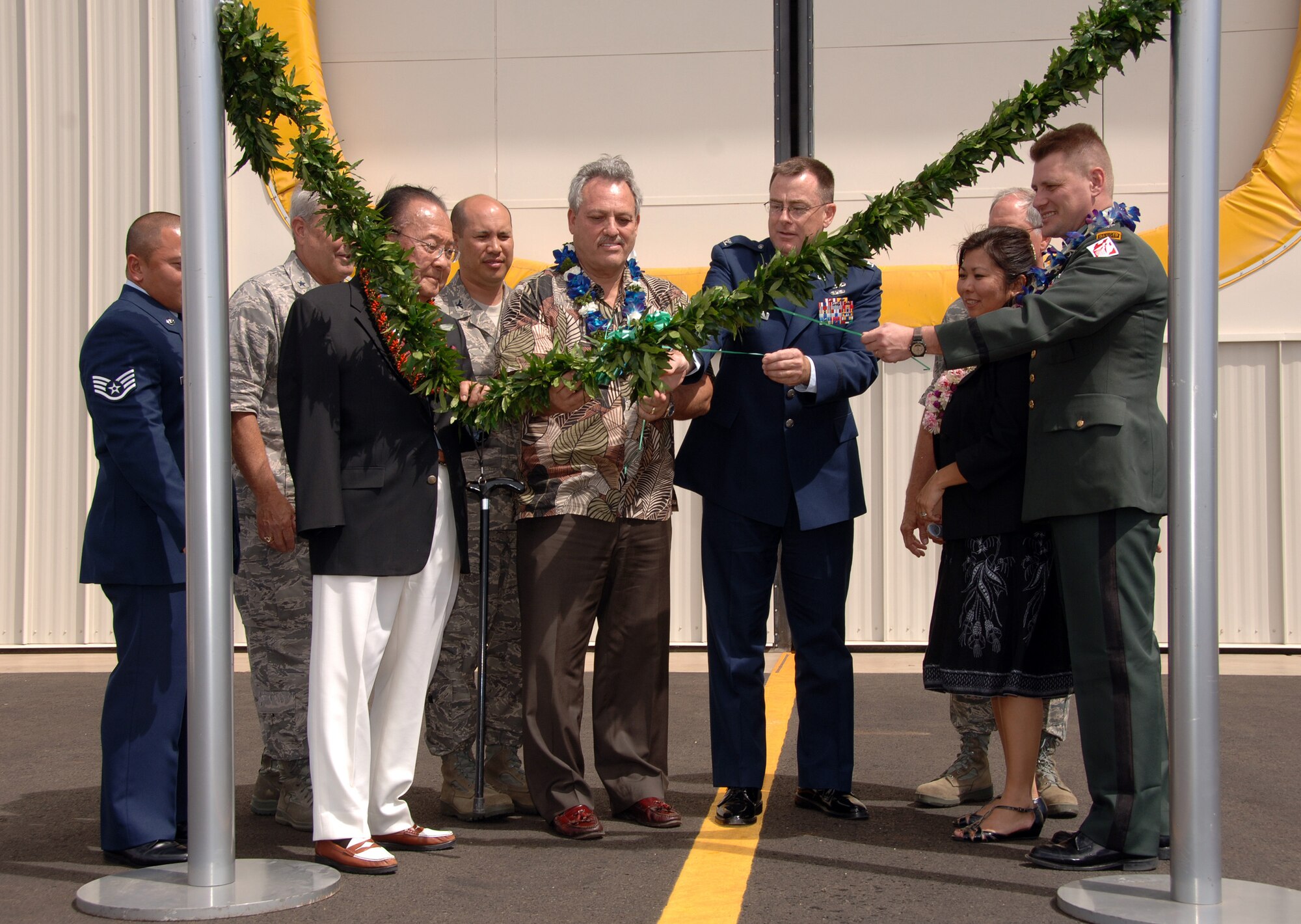 HICKAM AIR FORCE BASE, Hawaii -- Senator Daniel Inoye, along with Pacific Air Forces and Hickam AFB senior leadership, participate in the opening ceremony and ribbon cutting of C-17 Fuel Cell Hanger 19, April 14. This $25 million facility is the only hangar in the state of Hawaii specifically designed for C-17 fuel tank maintenance. It will greatly enhance Hickam AFB's capacity to maintain and repair assigned as well as transient aircraft ensuring aircraft availability throughout the Pacific theater. It also provides an enclosed area for fuel cell maintenance which can support multiple airframes not limited to the C-17, KC-135, C-40, C-37, C-130, and KC-10. (U.S. Air Force photo by Vanessa M. Perez) 