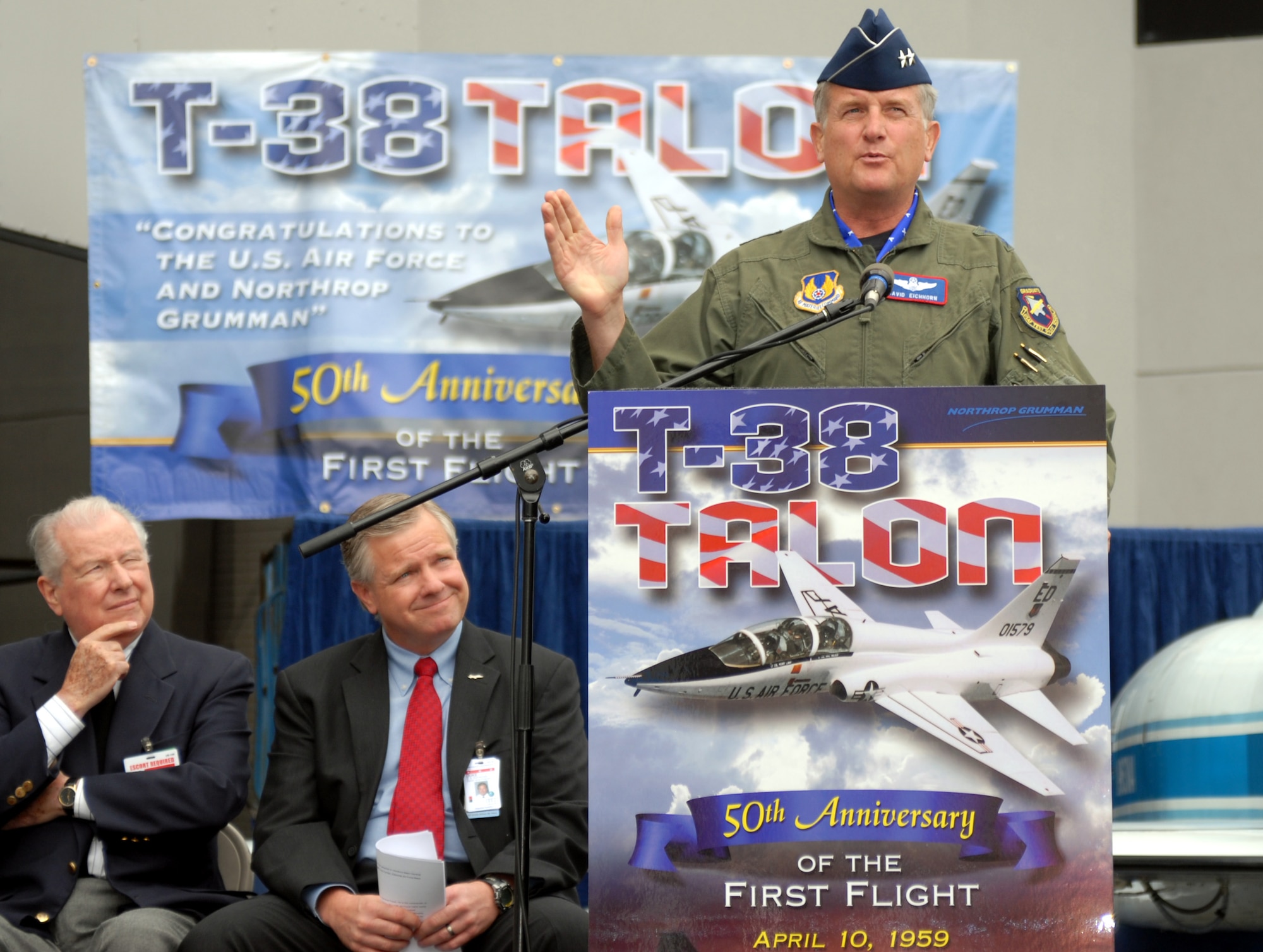 Maj. Gen. David Eichhorn, commander of the Air Force Flight Test Center at Edwards Air Force Base, Calif., speaks at the Northrop Grumman facility in El Segundo, Calif., April 10 during the commemoration of the T-38 Talon?s first flight fifty years ago on April 10, 1959.  Duke Dufresne (center), sector vice president and general manager of the Strike and Surveillance Systems division of Northrop Grumman Aerospace Systems, and Dan Rooney, former Northrop Aircraft Division vice president, also provided remarks during the event. (U.S. Air Force photo by Michael Briggs)