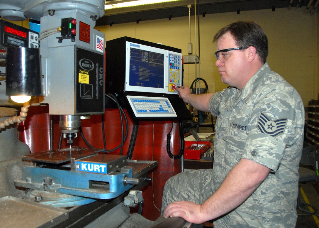 Tech. Sgt. Sam Heinert operates the Computer Numeric Control (CNC) equipment in the machine shop.