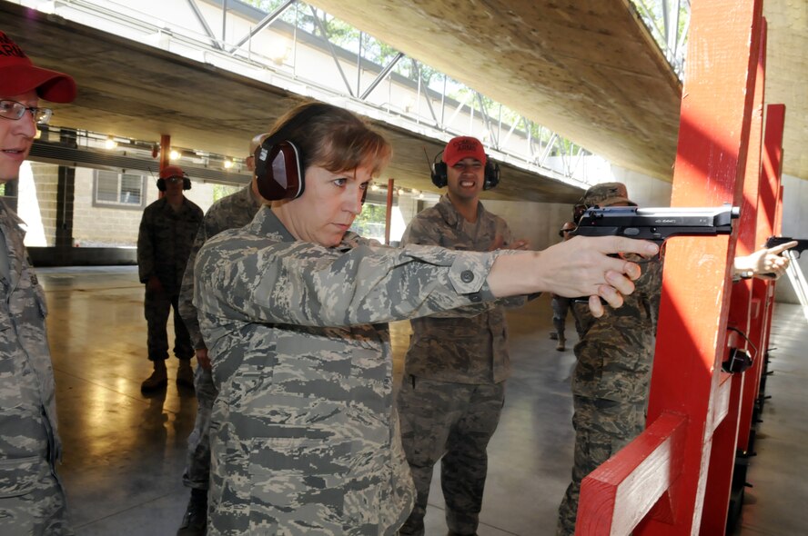 Col. Debra Bean, 78th Air Base Wing vice commander uses an M-9mm Barretta to fire the first shot at the  official opening April 15 of the 78th  25meter fully contained range. The range underwent a $4.7 million upgrade. It has increased the firing points from 13 to 24 Shooters. Students are able to move from different distances while the targets remain at a fixed location. Fixed targets eliminate the need for the shooters to cross the firing line, thus eliminating a safety concern. The range also received a $250,000 upgrade to its bullet containment trap, making it an environmentally friendly firing range. Along with the elimination of firing lead rounds, the new filtration system aides in making RAFB an environmentally friendly base. U. S. Air Force photo by Sue Sapp