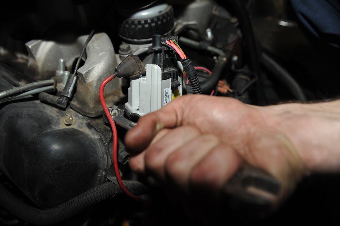 Airman 1st Class Joseph Martincic, 28th Logistics Readiness Squadron vehicle maintenance, tightens a bolt while changing a glow plug controller in a van here, April 14. The glow plug controller regulates voltage to the glow plugs for a specified period of time to assist with cold starts. (U.S. Air Force photo/Airman 1st Class Joshua J. Seybert)