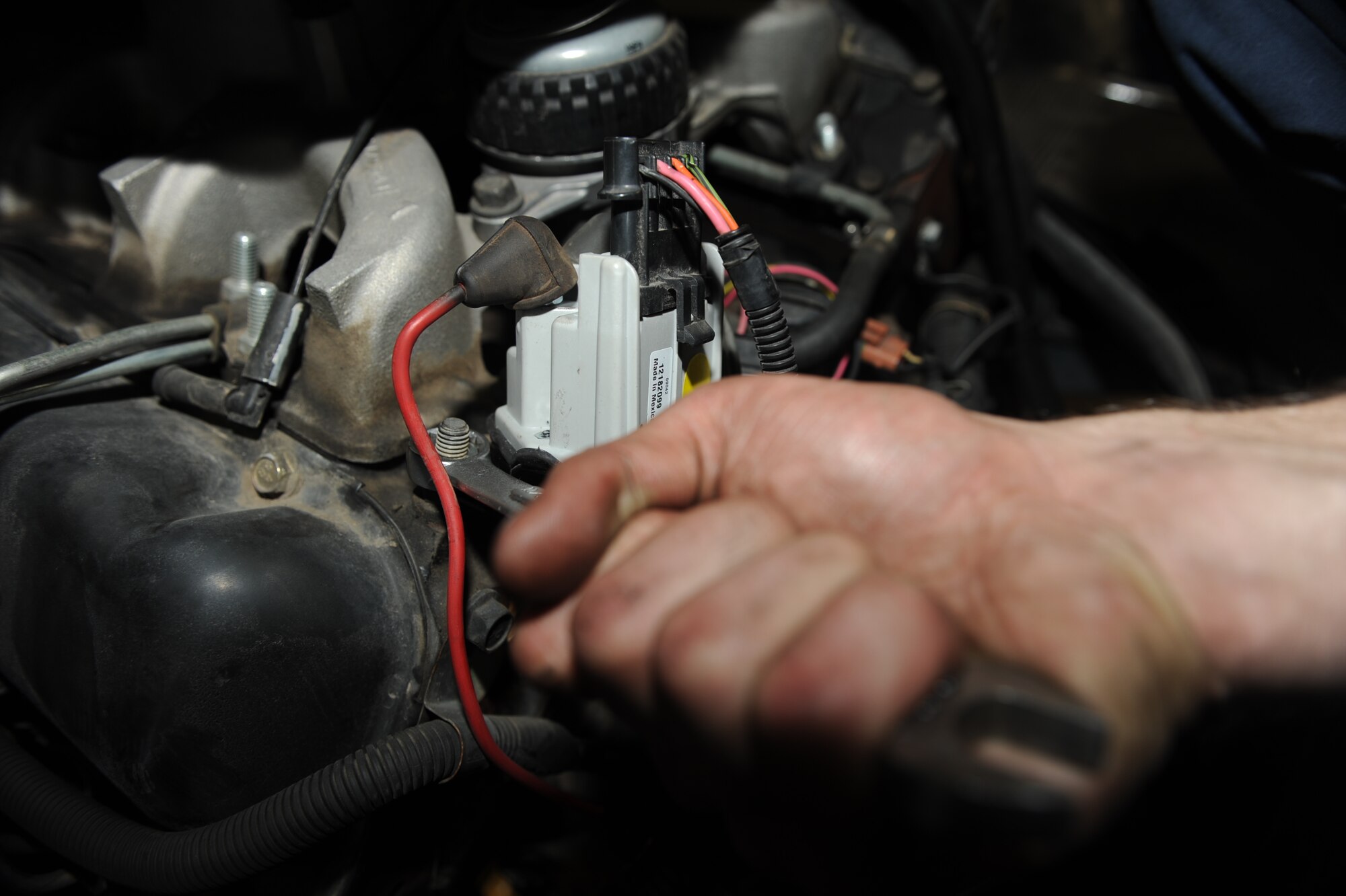 Airman 1st Class Joseph Martincic, 28th Logistics Readiness Squadron vehicle maintenance, tightens a bolt while changing a glow plug controller in a van here, April 14. The glow plug controller regulates voltage to the glow plugs for a specified period of time to assist with cold starts. (U.S. Air Force photo/Airman 1st Class Joshua J. Seybert)