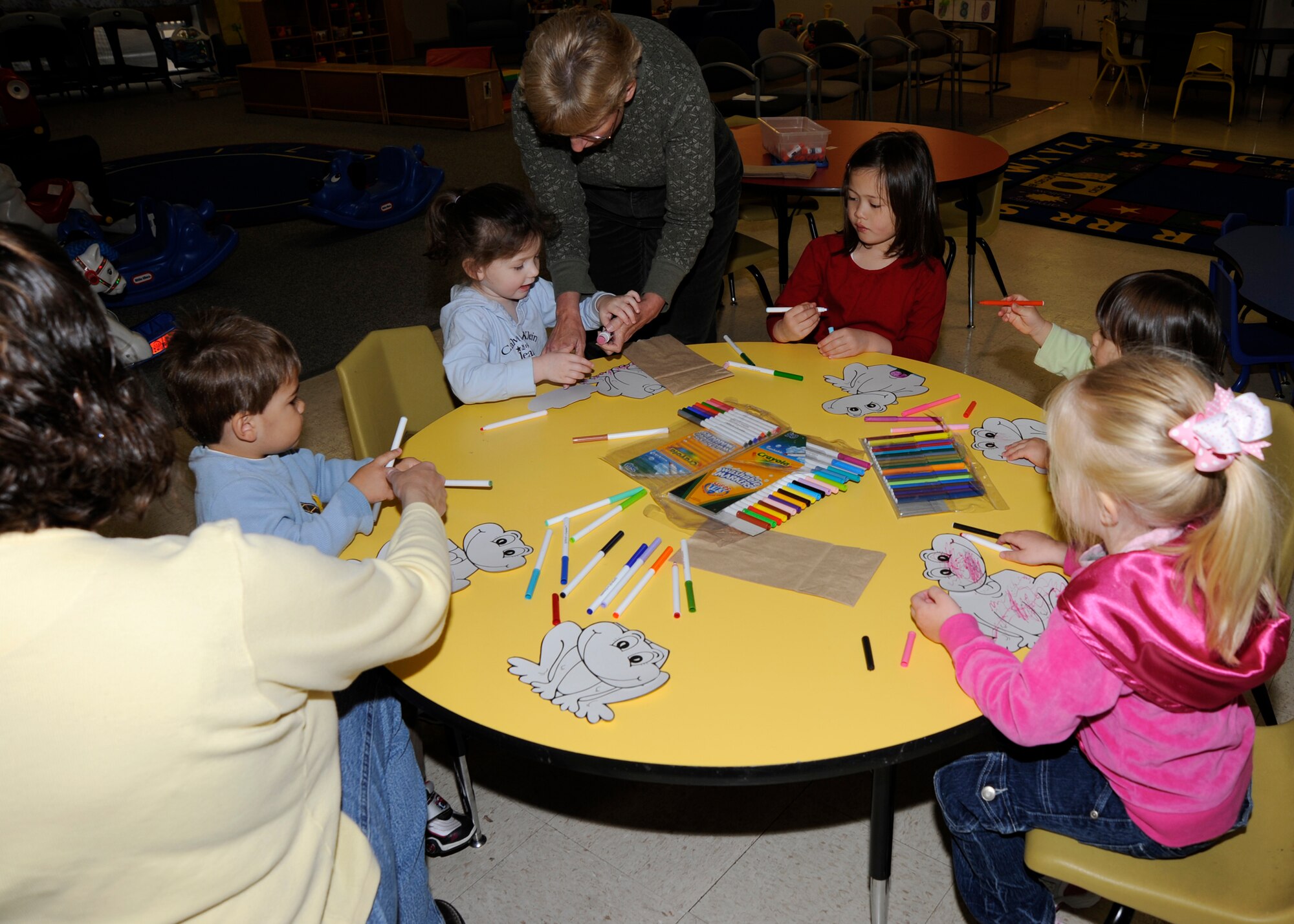 Team McConnell children colored and assembled frog puppets at the base playgroup for frog day, April 13. After making puppets, the children ate snacks, learned interesting frog facts, danced, sang and read books about frogs. (Photo by Airman Justin Shelton)
