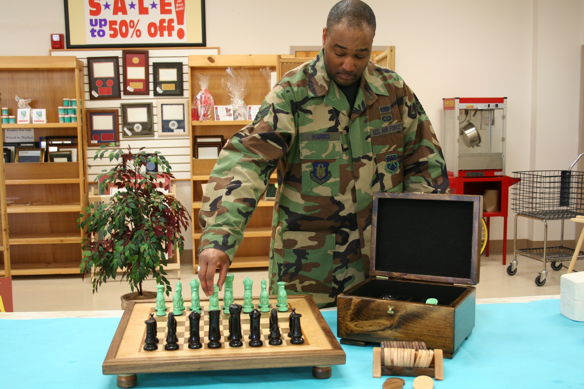 Airman Smith displays his handcrafted chess set.  (U.S. Air Force photo by Earlene Smith)