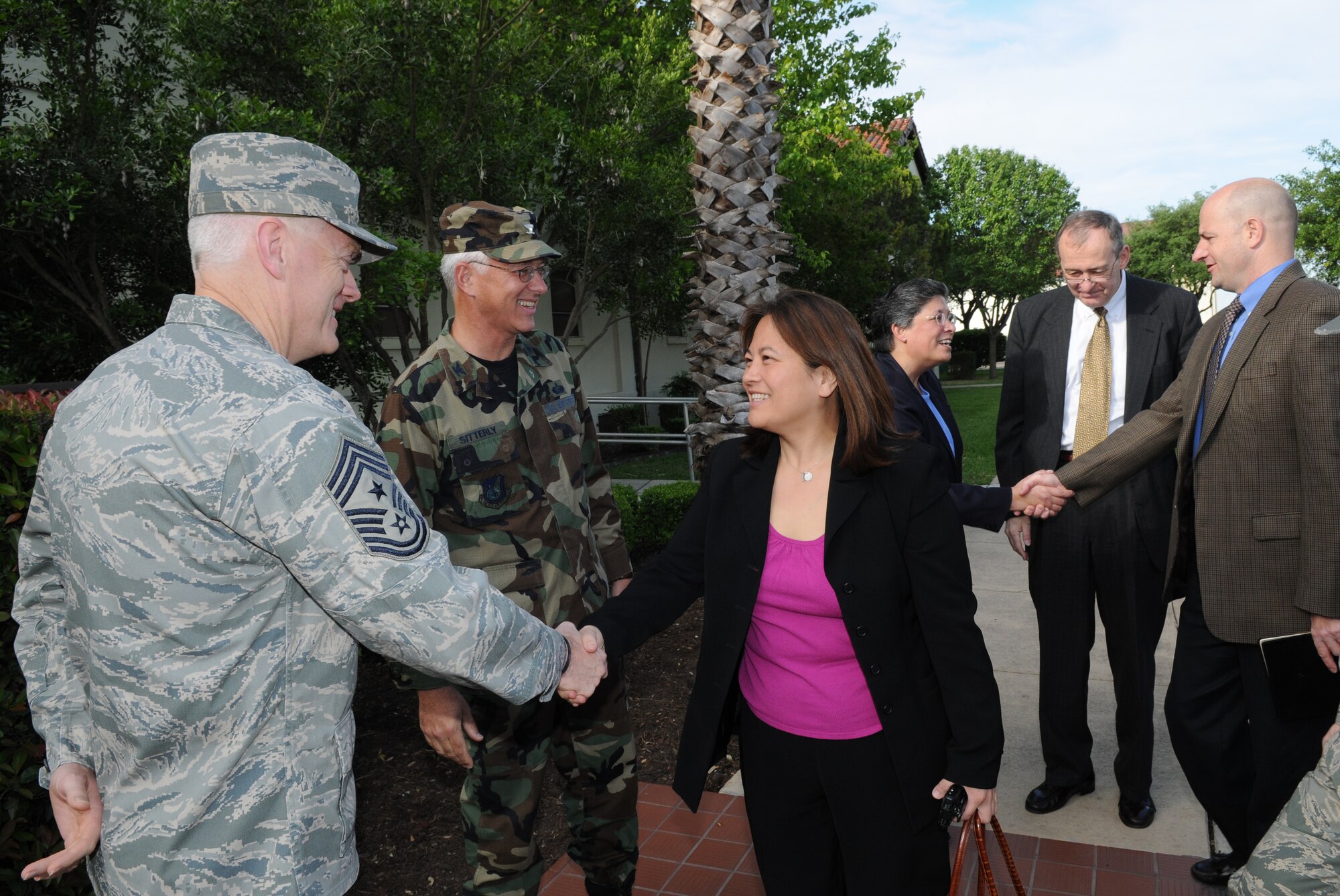 Chief Master Sgt. Andy Kaiser, Air Force Personnel Center command chief, greets Debra Wada, a staff member from the House Armed Services Committee's subcommittee on military personnel, outside AFPC April 15. (U.S. Air Force photo/Rich McFadden) 
