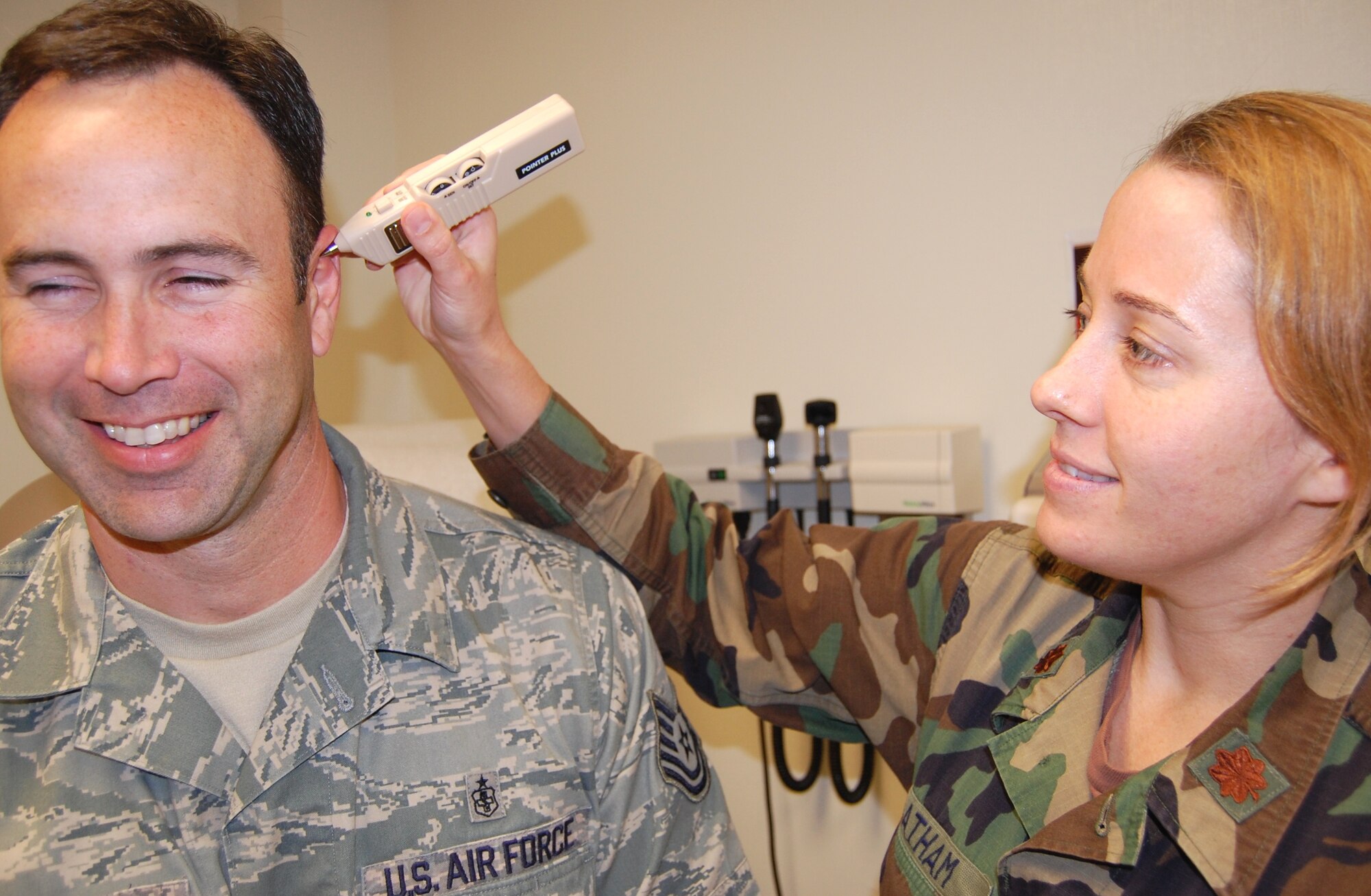 Major Latham uses a “Pointer Plus” to help find sensitive areas on Tech. Sgt. Fred Woodruff’s ear.  These areas lessen a patient’s pain.  Major Latham explained, “The ear is like a miniature body; if a patient has back pain, there is a spot on the ear that will reduce it through acupuncture.”  Sergeant Woodruff is noncommissioned officer in charge of the plastic surgery clinic.   (U.S. Air Force photo by Steve Pivnick)