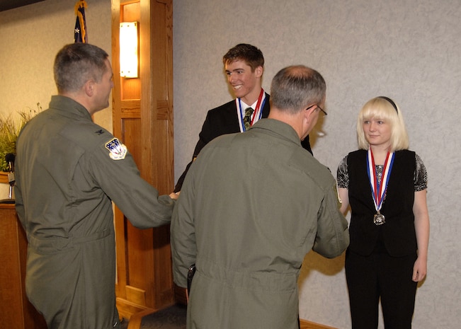 Col. Michael Fortney, 341st Missile Wing commander and Col. Paul Gydesen, 341st MW vice commander shake hands with Congressional Award winners Ashley Moore and Derek Lair April 9 in the 341st MW conference room. Congressman Denny Rehberg presented the teens with bronze and silver medals. Derek also earned a gold medal, which he will receive June 25 on Capitol Hill in Washington, D.C. (U.S. Air Force photo/Beau Wade)