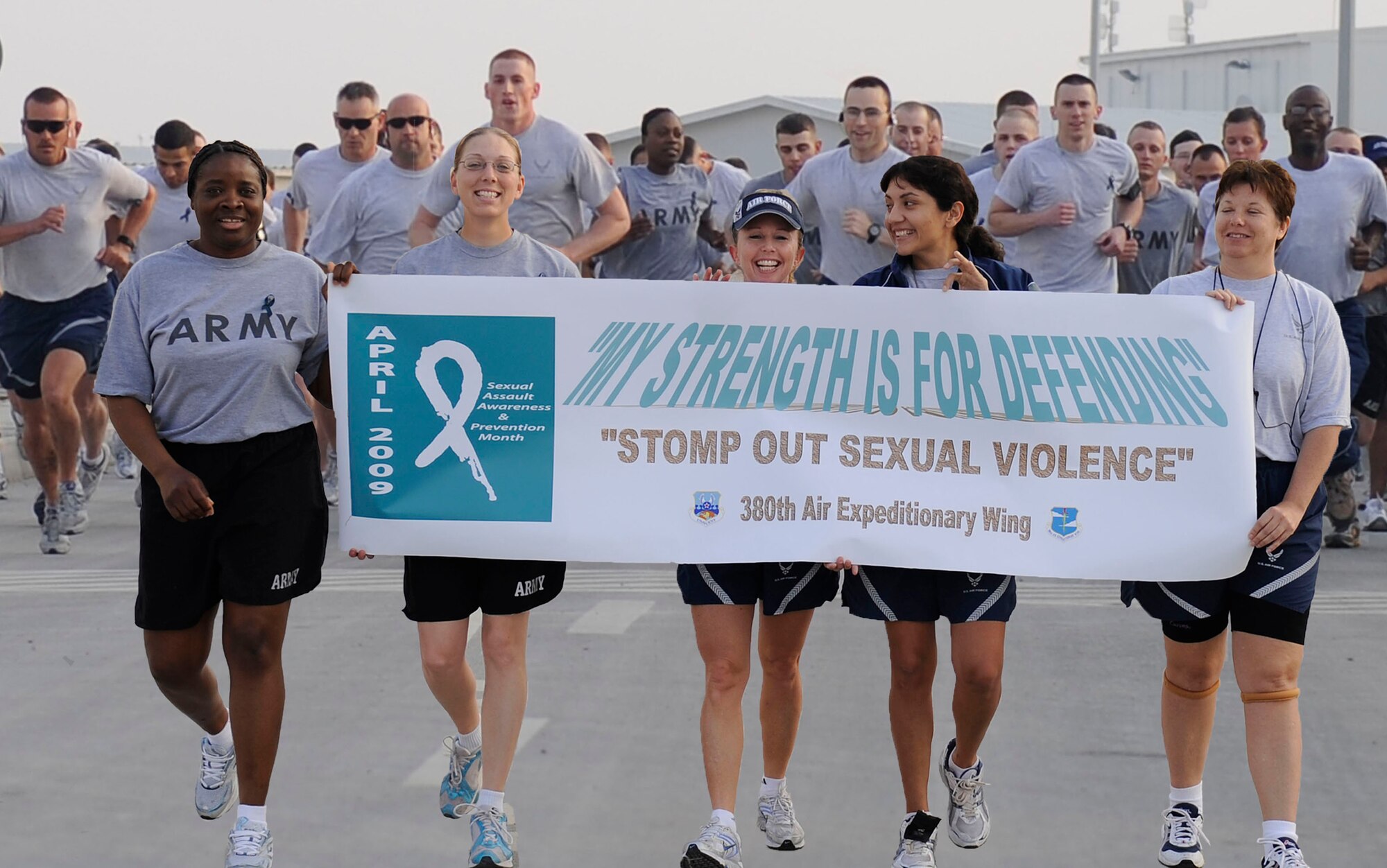 Airmen and Soldiers from the 380th Air Expeditionary Wing at an air base in Southwest Asia participated in a 1 mile walk and 5k and 10k runs April 8 as part of Sexual Assault Awareness and Prevention Month. (U.S. Air Force photo illustration/Senior Airman Brian J. Ellis)