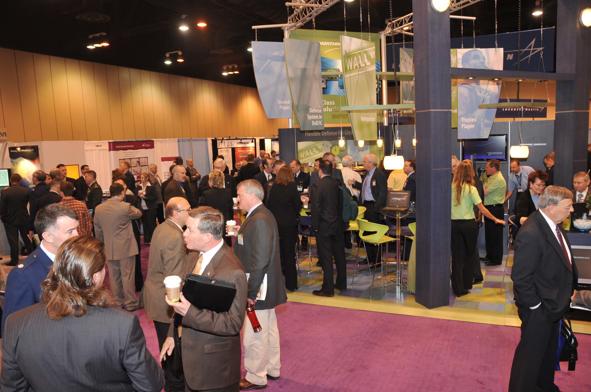 Symposium attendees visit the product display booths in exhibit hall during the Cyberspace Symposium at the Quest Center in Omaha, Neb. April 7-8. The theme for the symposium was "Advancing Cyberspace Capabilities to Deliver Integrated Effects."  Symposium sessions included perspectives from senior Department of Defense, U.S. and Allied government, industry, and academia speakers. US Air Force photo by Stephen J. Cunningham