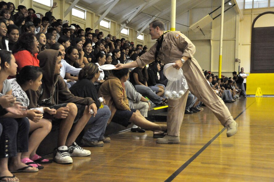 KONA, Hawaii -  U.S. Air Force Band of the Pacific - Hawaii saxophonist Tech Sgt. Joshua Fedele throws hands out Air Force frisbees  during a performance at Kohala High School on April 9, as part of a community outreach program. (U.S.  Air Force photo/Tech Sgt. Cohen A. Young)