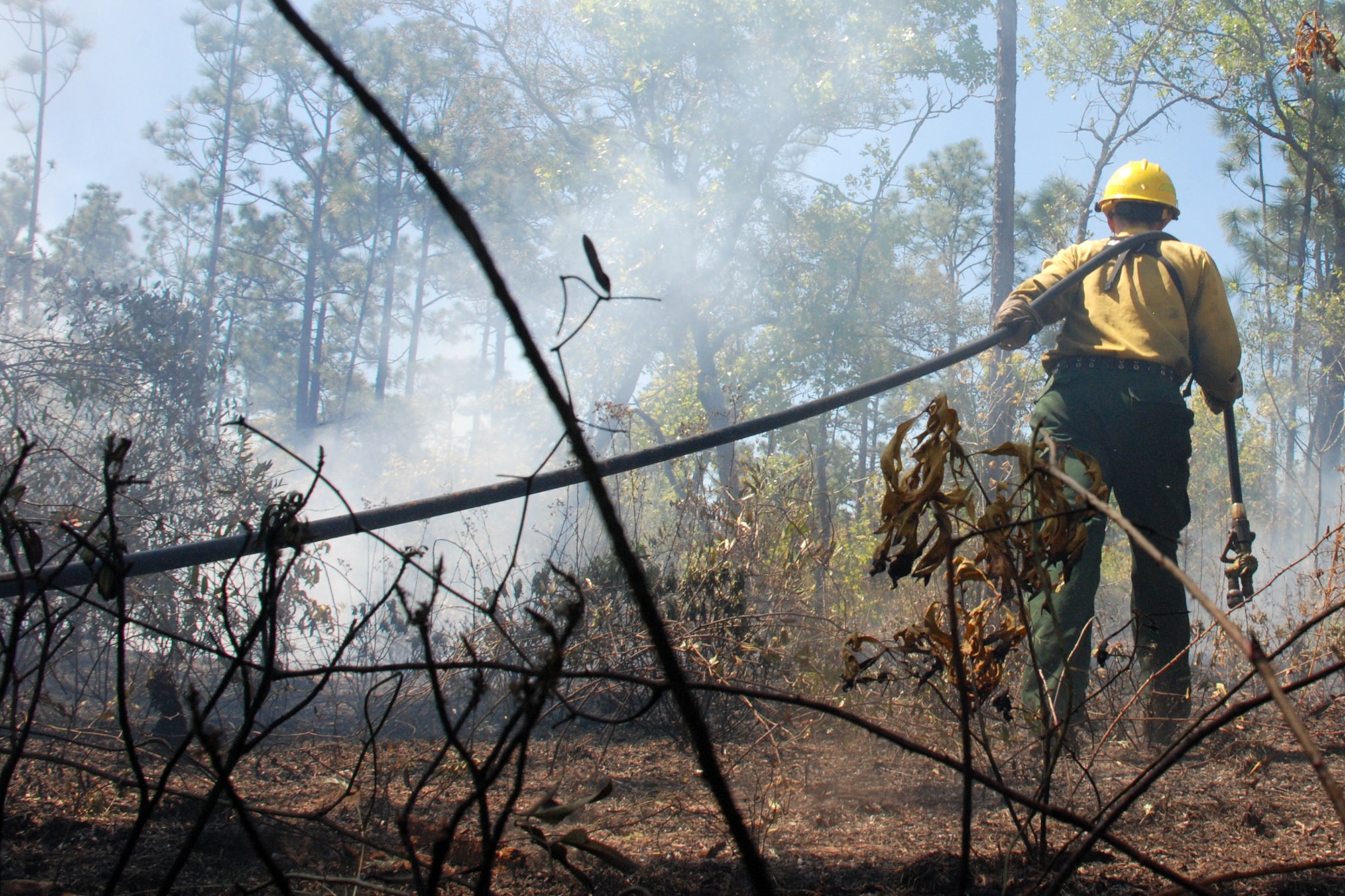 EGLIN AIR FORCE BASE, Fla. -- Amy Galetka, Eglin Natural Resources prescribed fire program technician, works to prematurely extinguish a fire line during prescribed burn operations April 8. The fire management technicians at Jackson Guard use prescribed fire techniques to keep a delicate longleaf pine ecosystem thriving while keeping the military mission a priority year round. Eglin is the largest Air Force base in the U.S. with more than 464,000 acres of land, and is home to more than 77 state and federally listed rare species. With more than 100,000 acres burned last season, the goal is to burn a five-year average of 70,000 acres per year. So far this season, the fire management program has burned more than 76,000 acres. The April 8 fire was called off early because of rapidly changing weather conditions and wildlife habitat endangerment. (U.S. Air Force photo/Mike Meares)
