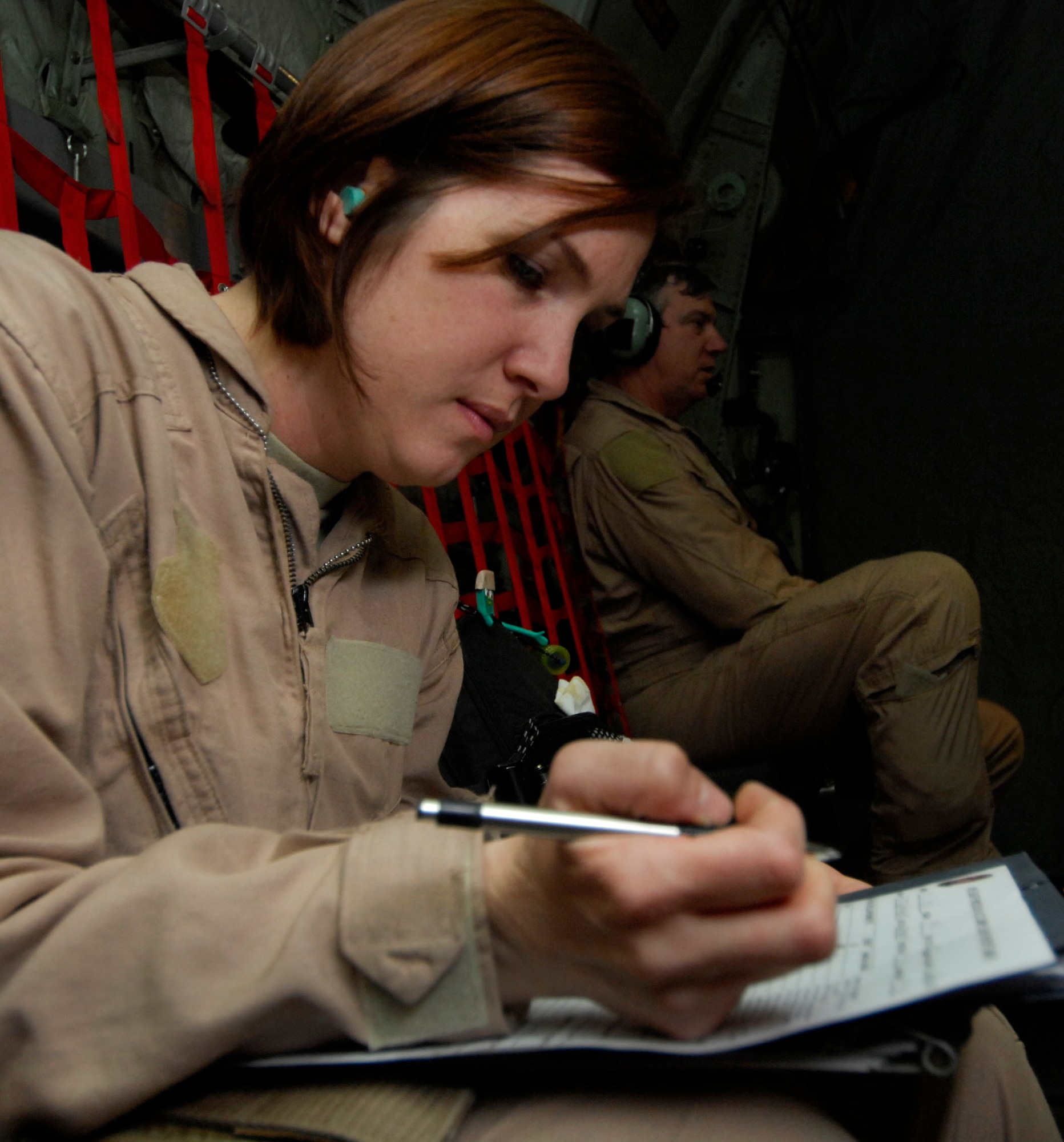 Capt. Susan McCormick keeps track of a patient's paperwork March 26 during an aeromedical evacuation flight to Bagram Airfield, Afghanistan. Captain McCormick, a flight nurse with the 455th Expeditionary Aeromedical Evacuation Flight at Bagram, is required to keep a log for each patient while enroute to their destination.  She is deployed from Westover Air Reserve Base, Mass. (U.S. Air Force photo/Senior Airman Erik Cardenas)