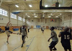 Adam Konstanzer shoots as Eric Rhodes, center, and Joseph Truesdale, right, wait for a rebound during an intramural basketball game at the Fitness and Sports Center April 14. SFS beat OSS 39 - 34. Konstanzer is assigned to the 437th Security Forces Squadron. Rhodes and Truesdale are assigned to the 437th Operations Support Squadron. (U.S. Air Force photo/Senior Airman Timothy Taylor)
