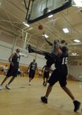 Darren Claverie, left, waits for a rebound as Errol Samuel, right, attempts to block a shot by Joseph Truesdale during the intramural basketball game at the Fitness and Sports Center April 14. SFS beat OSS 39 - 34. Claverie and Samuel are assigned to the 437th Security Forces Squadron. Truesdale is assigned to the 437th Operations Support Squadron. (U.S. Air Force photo/Senior Airman Timothy Taylor)