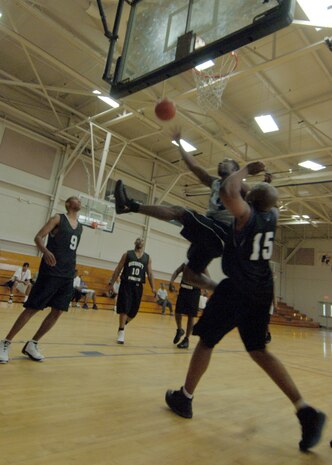 Darren Claverie, left, waits for a rebound as Errol Samuel, right, attempts to block a shot by Joseph Truesdale during the intramural basketball game at the Fitness and Sports Center April 14. SFS beat OSS 39 - 34. Claverie and Samuel are assigned to the 437th Security Forces Squadron. Truesdale is assigned to the 437th Operations Support Squadron. (U.S. Air Force photo/Senior Airman Timothy Taylor)