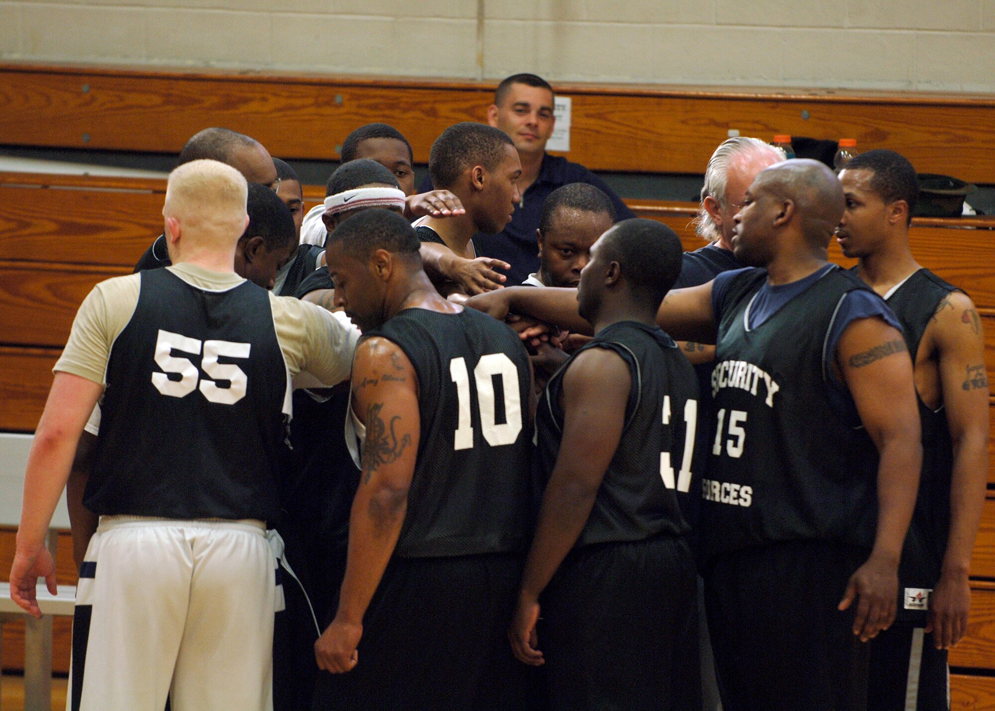 437th Security Forces team members prepare for the start of their intramural basketball game against the 437th Operations Support Squadron at the Fitness and Sports Center April 14. SFS beat OSS 39 - 34. (U.S. Air Force photo/Senior Airman Timothy Taylor)
