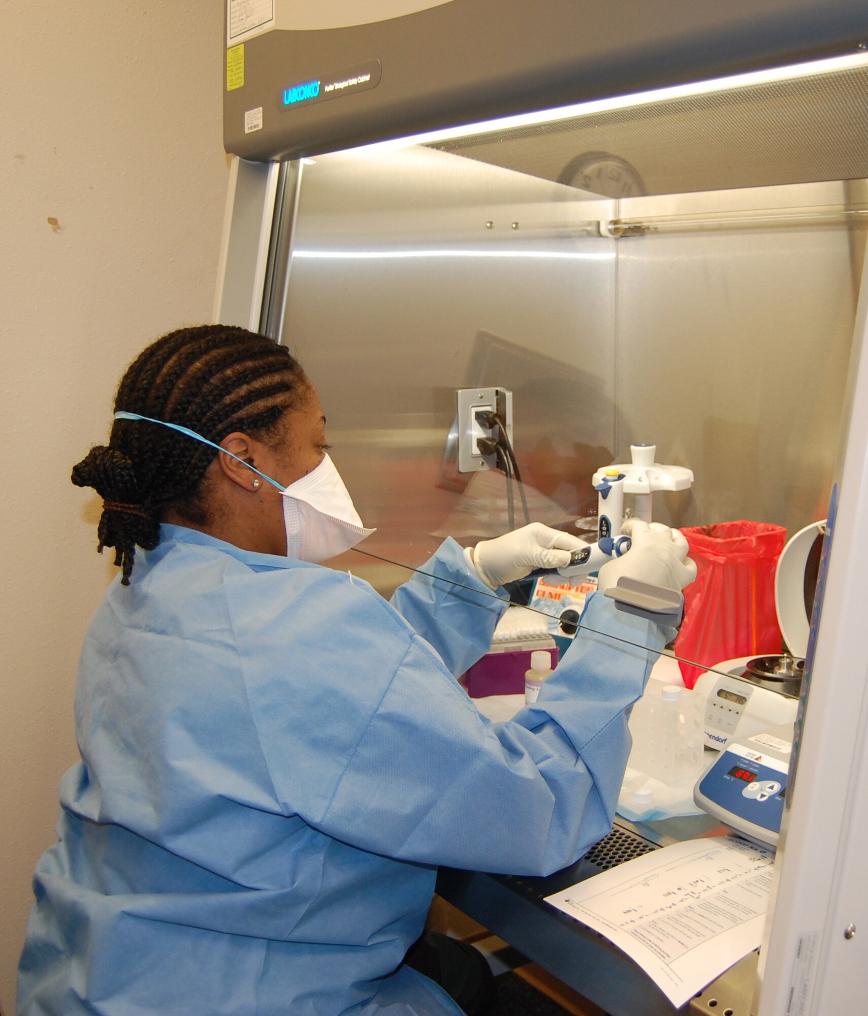 Tech. Sgt. Tiffany Sykes goes through one of the many steps required to test a specimen in the Joint Biological Agent Identification System. Sergeant Sykes is the assistant NCOIC of Laboratory Services here. (U.S. Air Force photo/Valerie Mullett)