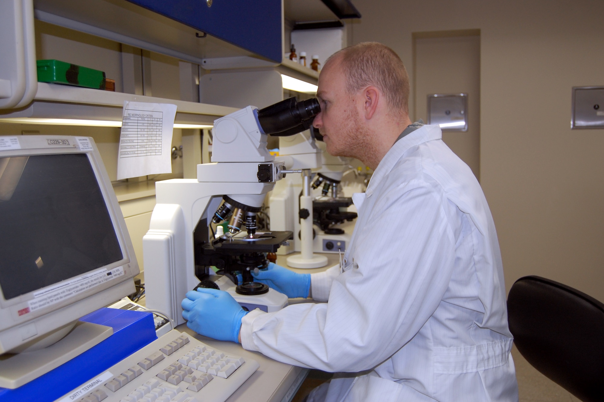 Staff Sgt. Jonathan Shields performs a manual differential test on a blood sample. Sergeant Shields is a medical laboratory technician with the 341st Medical Support Squadron. (U.S. Air Force photo/Valerie Mullett)