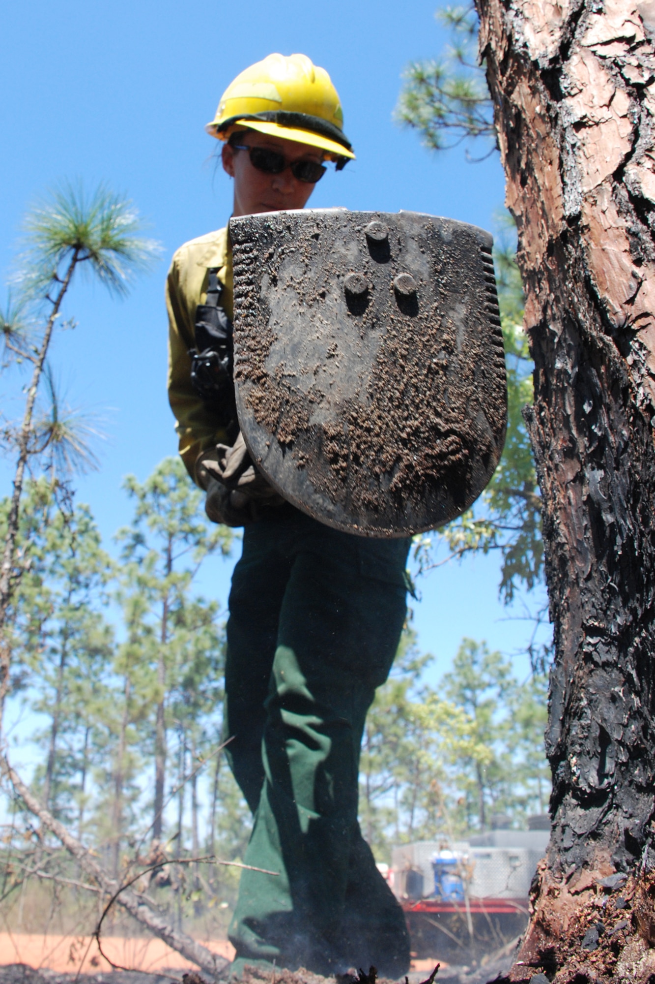 EGLIN AIR FORCE BASE, Fla. -- Amy Galetka, Eglin Natural Resources prescribed fire program technician, uses a combination tool to extinguish smoldering fuels during prescribed burn operations April 8. The fire management technicians at Jackson Guard use prescribed fire techniques to keep a delicate longleaf pine ecosystem thriving while keeping the military mission a priority year round. Eglin is the largest Air Force base in the U.S. with more than 464,000 acres of land, and is home to more than 77 state and federally listed rare species. With more than 100,000 acres burned last season, the goal is to burn a five-year average of 70,000 acres per year. So far this season, the fire management program has burned more than 76,000 acres. The April 8 fire was called off early because of rapidly changing weather conditions and wildlife habitat endangerment. (U.S. Air Force photo/Mike Meares)