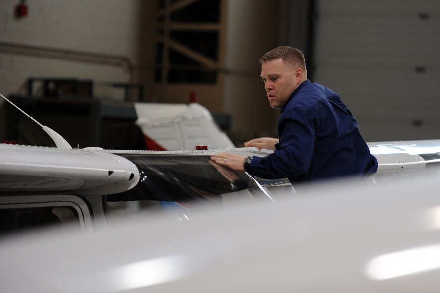 OFFUTT AIR FORCE BASE, Neb.- Scott Voichoskie, an instructor at the LeMay Aero Club, inspects the wing of a Cessna 172 in the aero club hangar, April 9. Mr. Voichoskie said one of the key concerns for flight instructors is safety. Each aircraft undergoes a thorough preflight inspection prior to leaving the hangar. U.S. Air Force Photo by Josh Plueger
