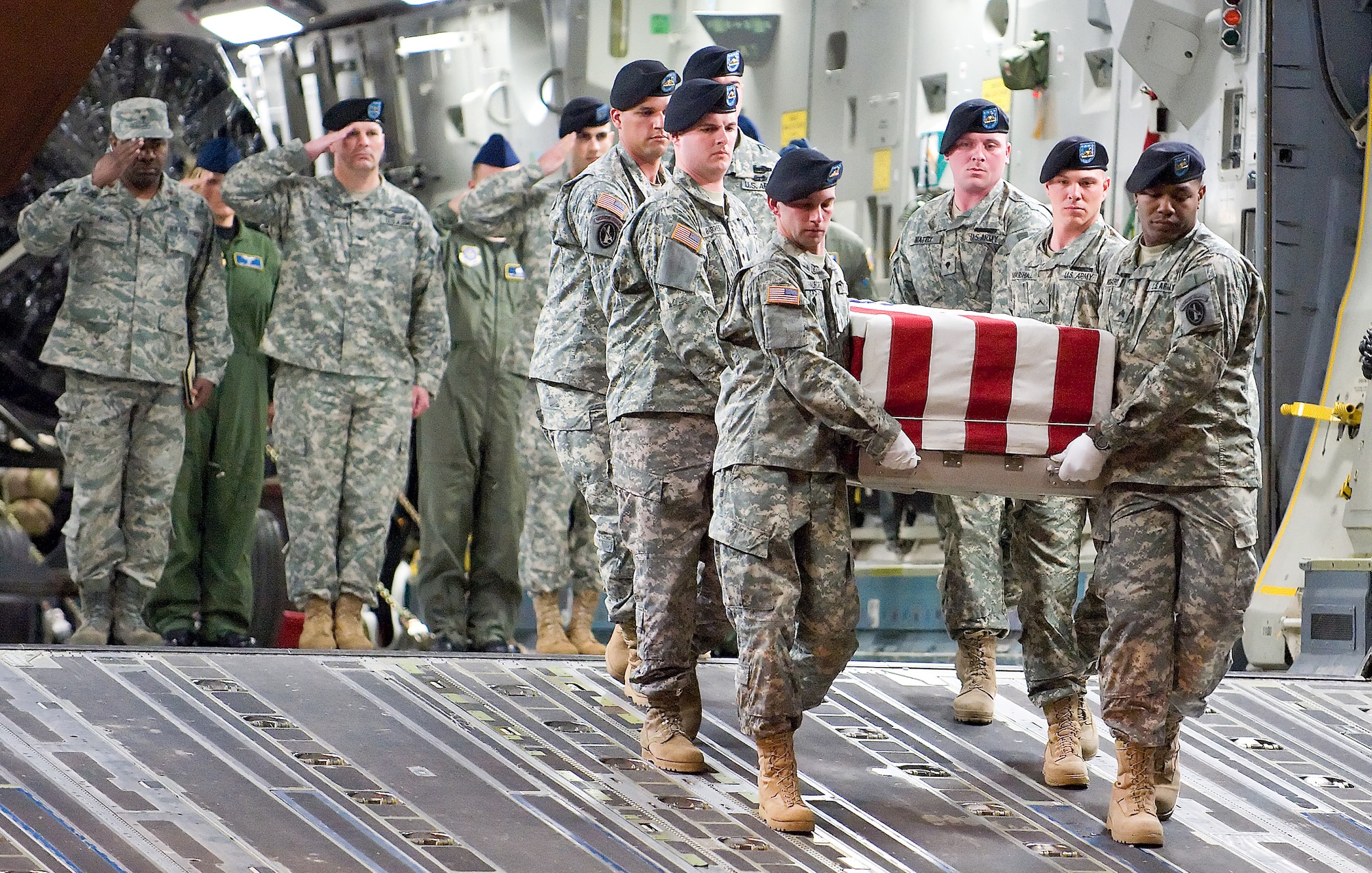 An Army carry team transfers the remains of Army Spc. Israel Candelaria Mejias off from a C-17 Globemaster III April 7 at Dover Air Force Base, Del. Specialist Candelaria Mejias of San Lorenzo, Puerto Rico, died April 5 of wounds sustained when a mine detonated near him during combat operations near Baghdad, Iraq. He was assigned to the 1st Battalion, 2nd Infantry Regiment in Task Force 3rd Battalion, 66th Armor Regiment, 172nd Brigade Combat Team from Grafenwoehr, Germany. The C-17 is assigned to Charleston AFB, S.C. (U.S. Air Force photo/Roland Balik) 
