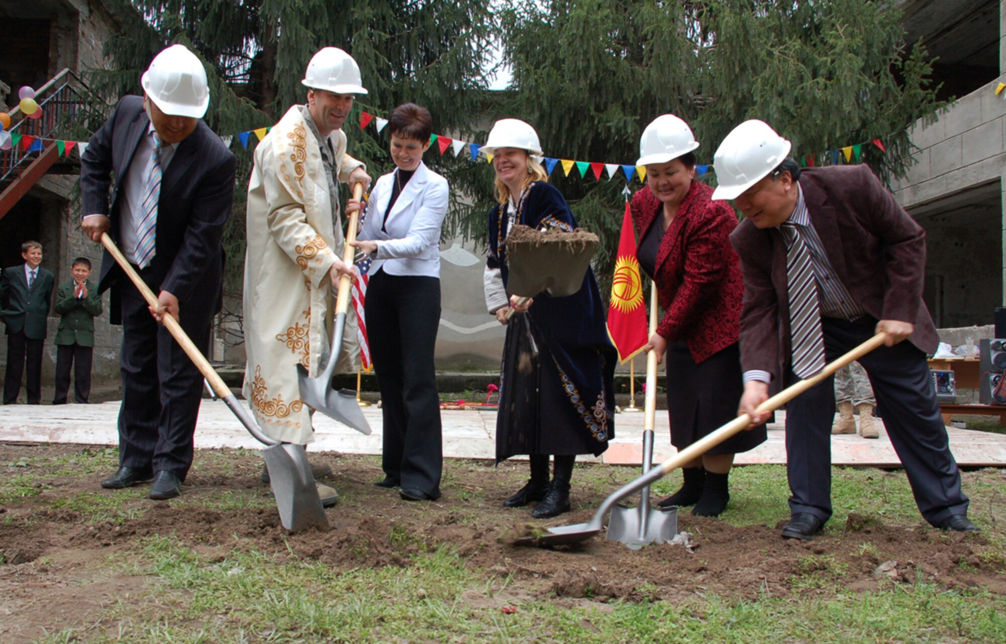 During a ground-breaking ceremony held April 14 for a renovation project at Birdik Village School, distinguished guests help break the soil to begin a $470,000 project to renovate the school. Currently, the children of Birdik Village walk nearly four miles each day to attend classes at a neighboring school. When complete in autumn 2009, the school will house 200 students. From left, Birdik Village Mayor Kydykeev Syrgak, Manas Air Base commander, Col. Christopher Bence, Birdik School Principal Olga Voroshihina, U.S. Ambassador to Kyrgyzstan Tatiana Gfoeller, District Council Chairwoman Ms. Aidakeyeva Asanovna and the foreman of the Imarat Stroy. (U.S. Air Force photo/Tech. Sgt. Phyllis Hanson)