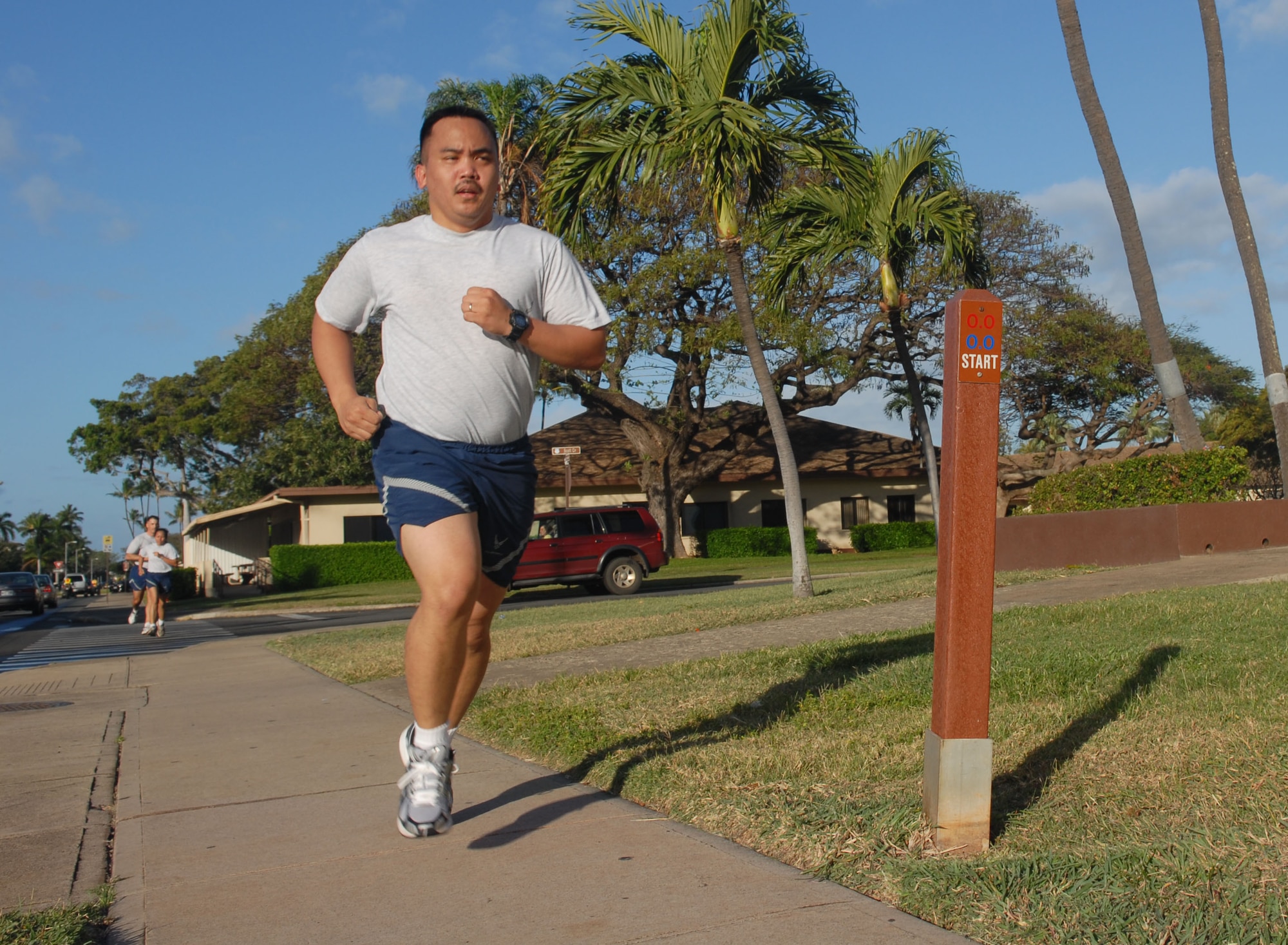 HICKAM AIR FORCE BASE, Hawaii -- Tech. Sgt. Leroy Lobitos, a member of the 15th Comptroller Squadron, finishes his 2-mile run in front of the Hickam AFB gym April 14. (U.S. Air Force photo by Ed Foster)